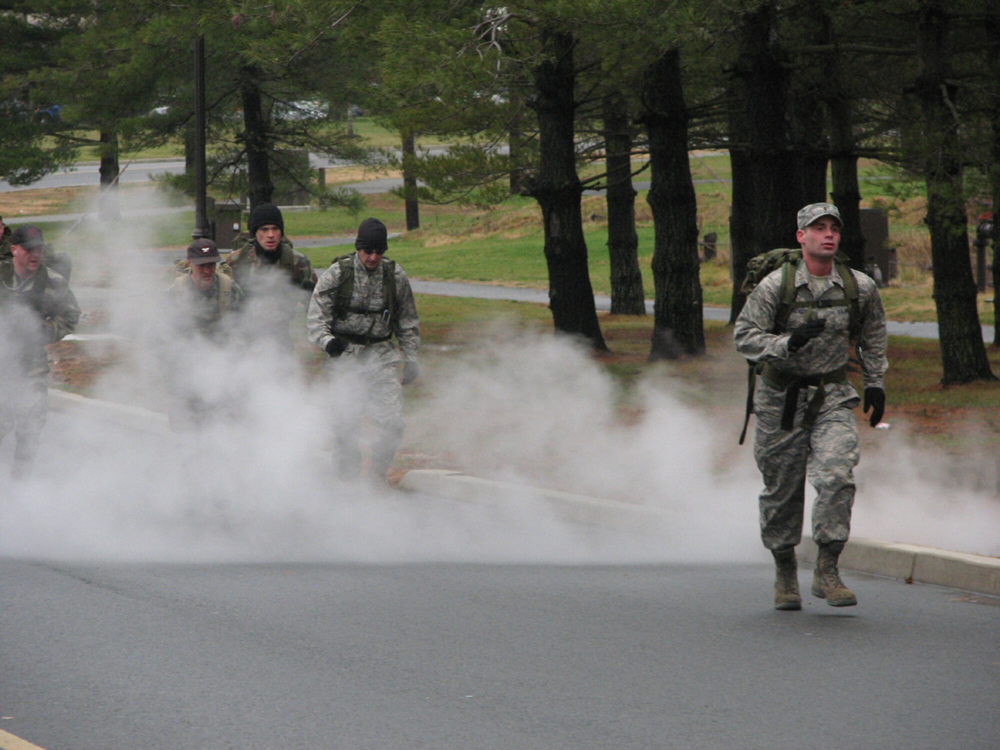 2nd Lt. Timothy Schaitberger, 819th Global Support Squadron, is stalked through the steam by the team from the 817th Contingency Response Group during the ruck march portion of the 621st Contingency Response Wing's Combat Sports Day, Dec 12. The half-day event also included a combat relay, land navigation, pallet build-up, combat volleyball, weapons assembly and tug-of-war. (U.S. Air Force photo/1st Lt. Dustin Doyle)
