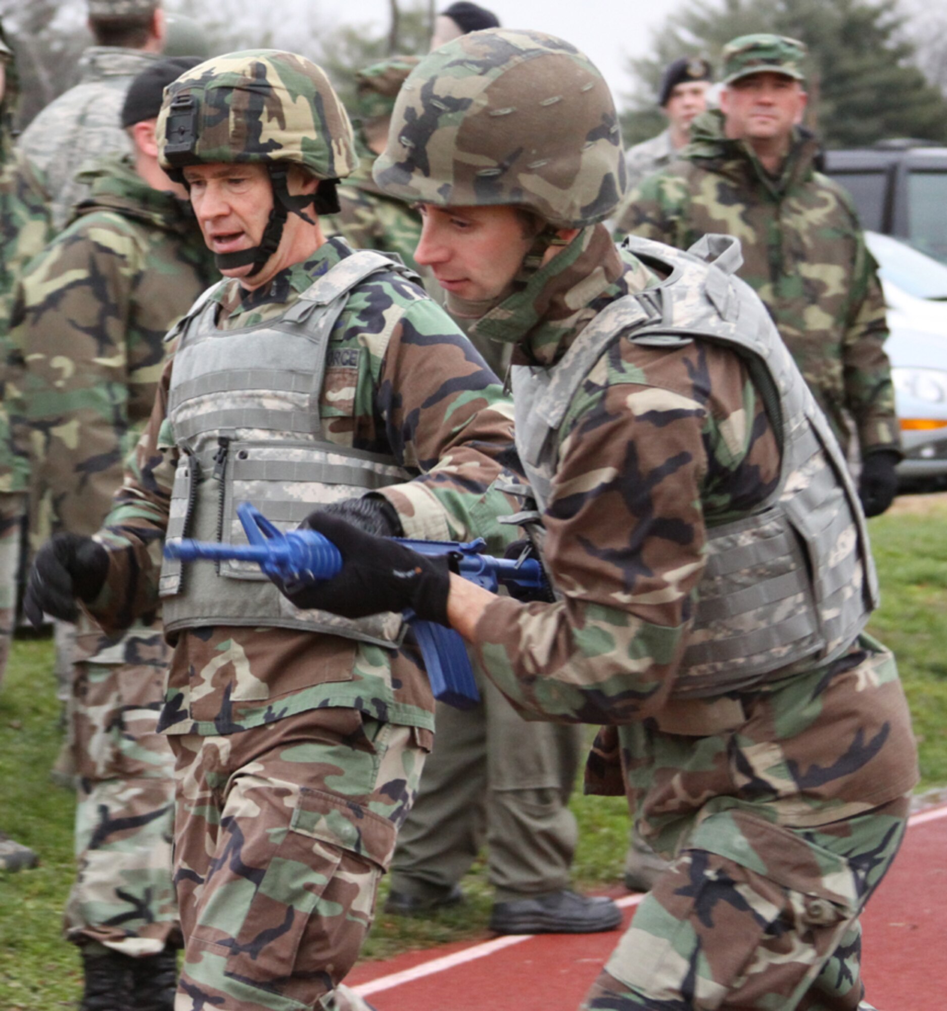 Col. Mark Ellis, 817th Contingency Response Group commander, hands off the "baton" to 2nd Lt. Ryan Fisher, 817th CRG logistics officer, during the combat relay portion of the 621st Contingency Response Wing's Combat Sports Day here, Dec. 12. The 817th CRG finished third in this event but rallied in the other events to claim overall first place for the day. (U.S. Air Force photo/Staff Sgt. Jonathan Kolasinski)