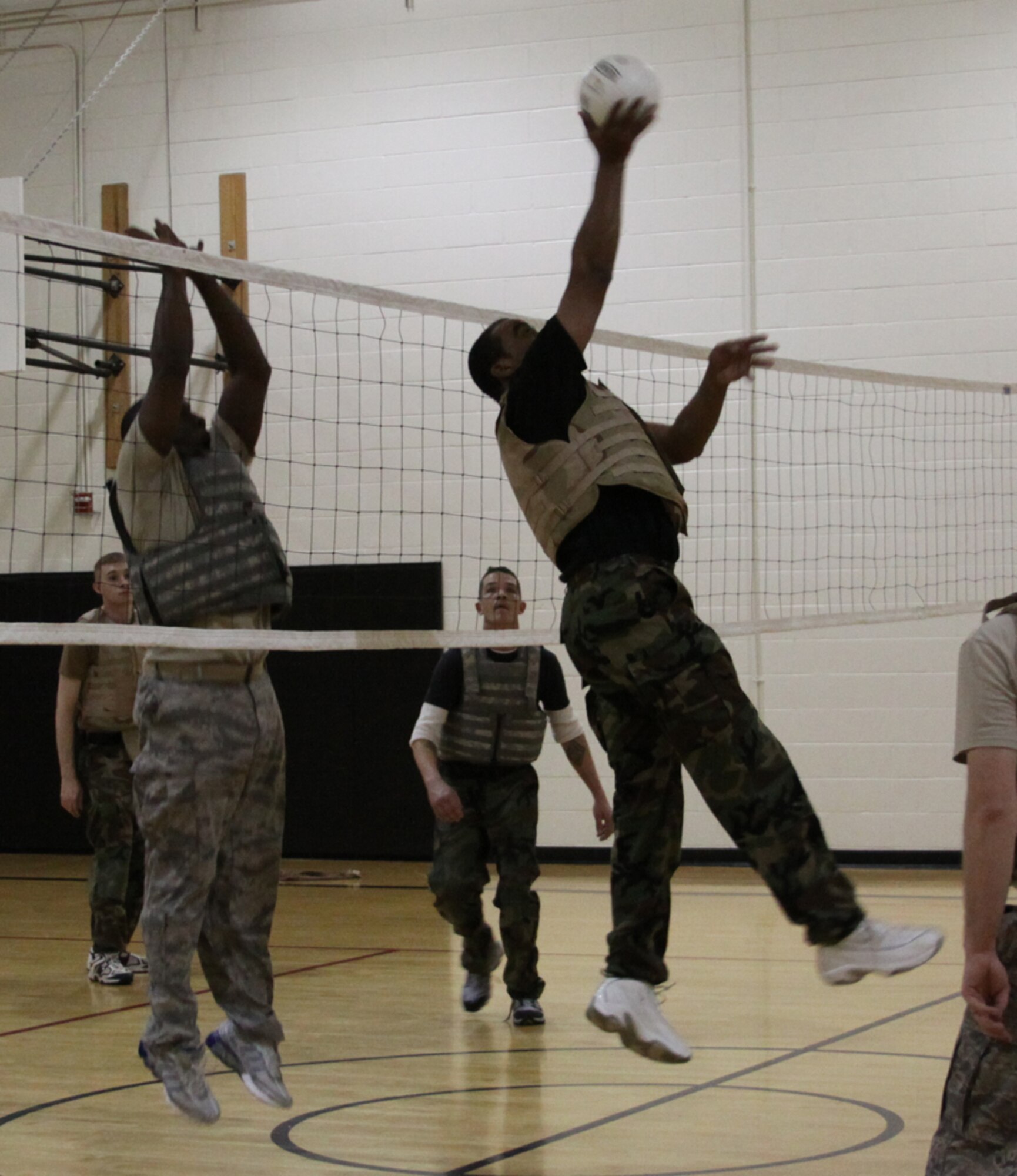 Master Sgt. Lamar Heard, 817th Contingency Response Group, attempts to block a shot by Master Sgt. Joe Baldwin, 21 Air Mobility Operations Squadron, during the combat volleyball portion of the 621st Contingency Response Wing's Combat Sports Day, Dec. 12. (U.S. Air Force photo/Staff Sgt. Jonathan Kolasinski)