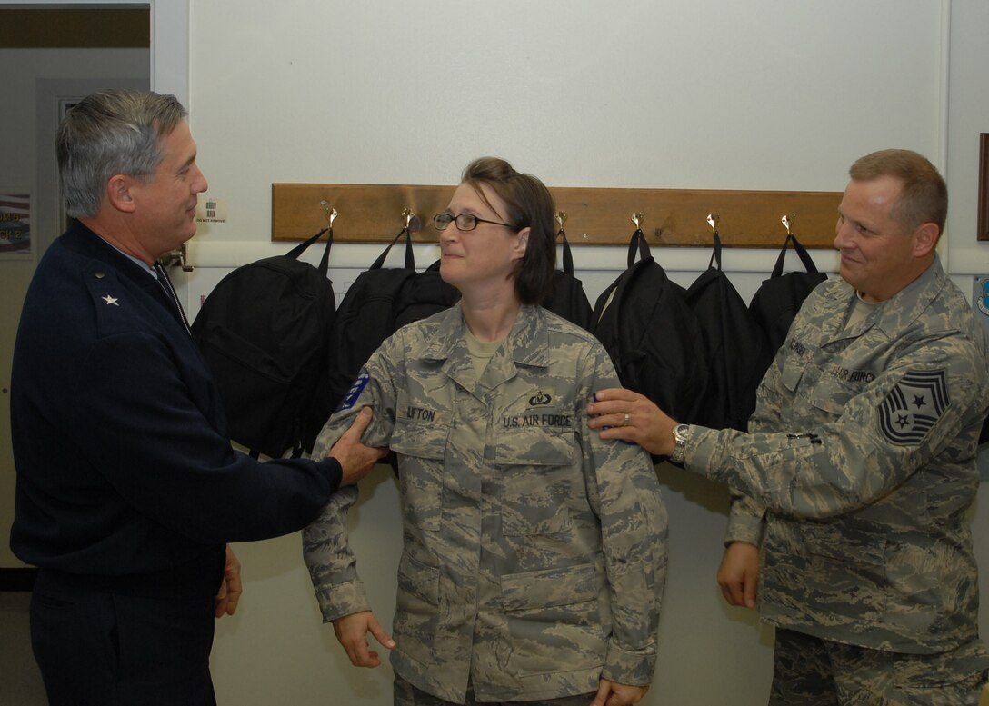 Brig. Gen. O.G. Mannon, 82nd Training Wing commander, and Command Chief of the 82nd TRW Chief Master Sgt. Kenneth Sallinger, promote Tondra Clifton, an instructor at the 361st Training Squadron, to technical sergeant with Stripes for Exceptional Performance Dec. 12. STEP promotions allow the ranks of staff sergeant to master sergeants to be promoted to the next rank without going through standard testing procedures. (U.S. Air Force photo/Lou Anne Sledge)