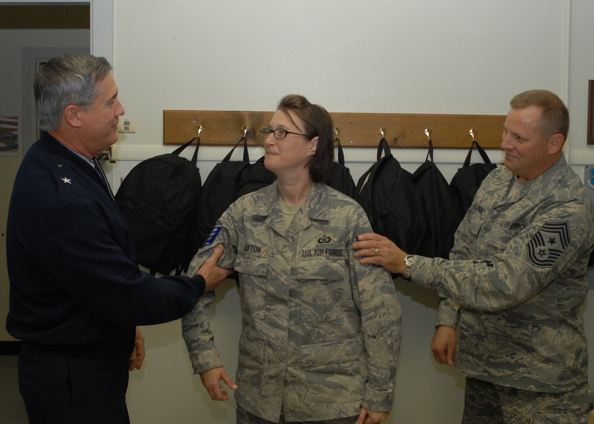 Brig. Gen. O.G. Mannon, 82nd Training Wing commander, and Command Chief of the 82nd TRW Chief Master Sgt. Kenneth Sallinger, promote Tondra Clifton, an instructor at the 361st Training Squadron, to technical sergeant with Stripes for Exceptional Performance Dec. 12. STEP promotions allow the ranks of staff sergeant to master sergeants to be promoted to the next rank without going through standard testing procedures. (U.S. Air Force photo/Lou Anne Sledge)