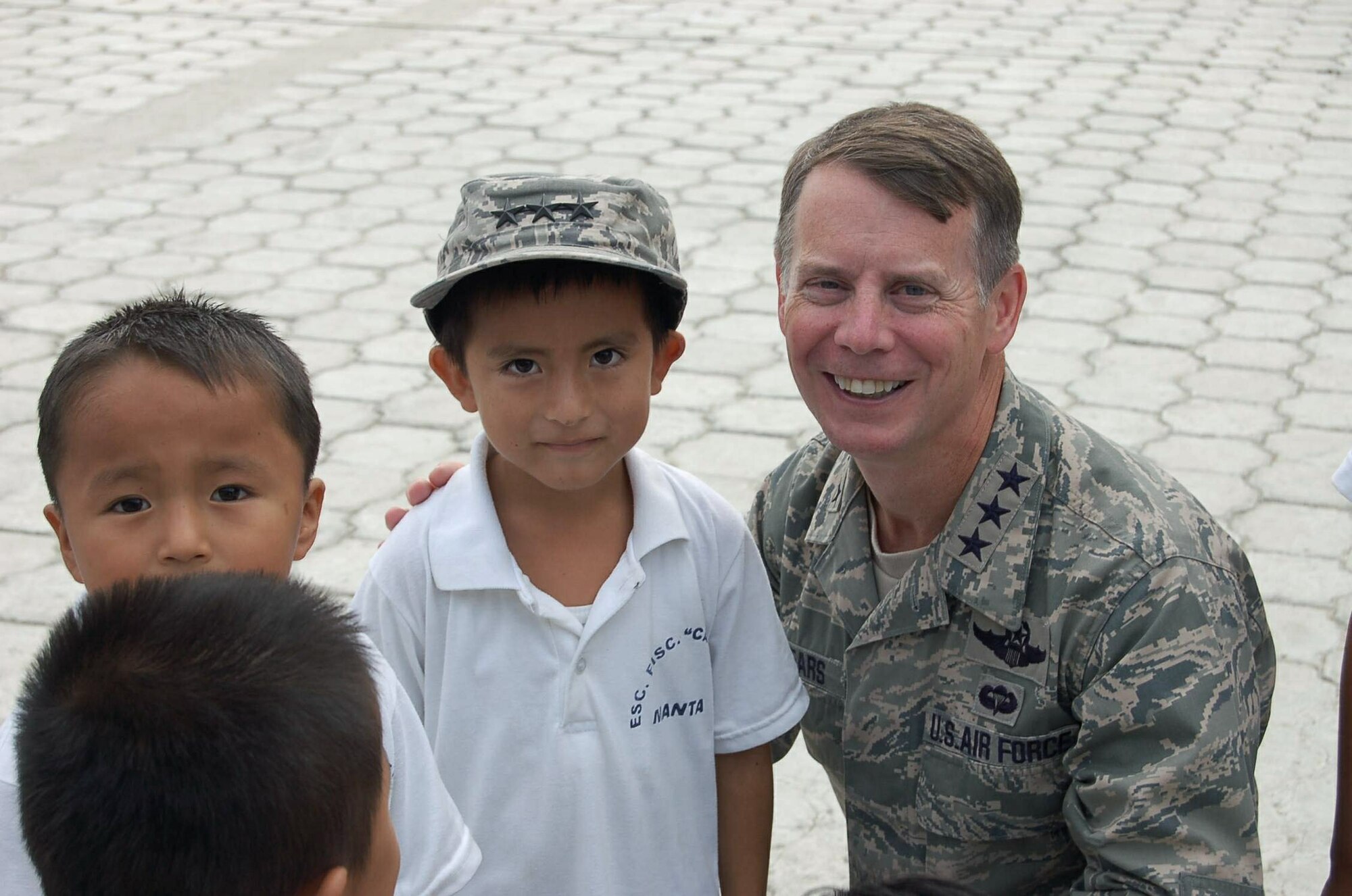 Lt. Gen. Glenn F. Spears gets acquainted with students from the San Juan Elementary School Dec. 10 in San Juan, Ecuador. The general presented a donation certificate for $6,000 in school supplies to the school's director in front of the nearly 330 children enrolled. General Spears is the Southern Command deputy commander. (U.S. Air Force photo/Tech. Sgt. Matthew McGovern) 