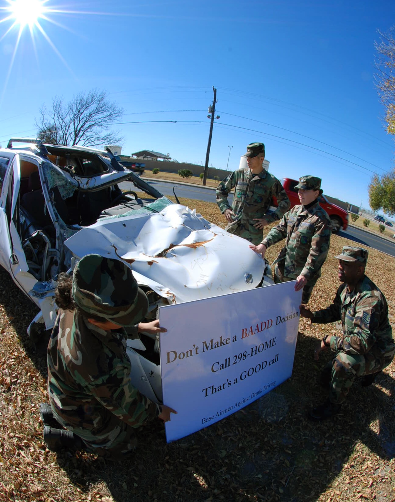 LAUGHLIN AIR FORCE BASE, Texas – Members of Base Airmen Against Drunk Driving set up a sign in front of a wrecked truck parked just before the main gate here to help promote the Base Airmen Against Drunk Driving program for the holidays Dec. 11. (U.S. Air Force photo by Airman 1st Class Sara Csurilla) 