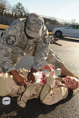 A member of the 4th Fighter Wing plays the role of a victim and receives assistance from an emergency responder in a training exercise held Dec. 8 - 12, 2008 at Seymour Johnson Air Force Base, N.C. Orbit Comet is an exercise held annually to test the responsiveness and inter-agency cooperation between local authorities and Seymour Johnson Air Force Base emergency responders. (U.S. Air Force photo by Airman 1st Class Ciara Wymbs)