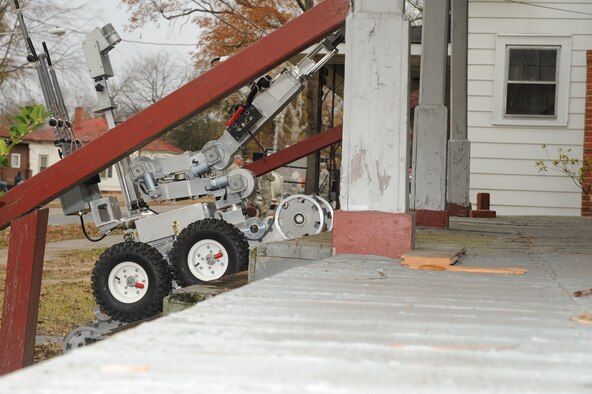 An F-6 Alpha robot controlled by explosive ordnance disposal specialists from the 4th Civil Engineer Squadron attempts to enter a house suspected to contain a bomb lab during a training exercise in downtown Goldsboro, N.C., Dec. 8 - 12, 2008. The training was part of Orbit Comet, an exercise held annually to test the responsiveness and interagency cooperation between local authorities and Seymour Johnson Air Force Base emergency responders. (U.S. Air Force photo by Airman 1st Class Ciara Wymbs)