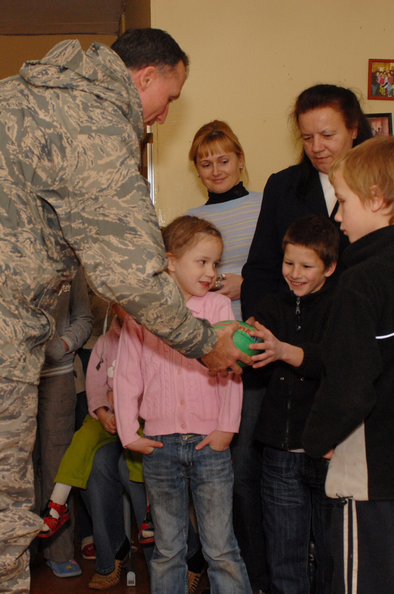 Brig. Gen.  Bill Bender delivers sports gear and other items to the District Vijurkai Children’s Home near Šiauliai, Lithuania, Dec 2. General Bender was in the area visiting the 1st Combat Communications Squadron deployed there, and capitalized on the squadron’s relationship with the children’s home to bring items donated by the 86th Airlift Wing. (U. S. Air Force photo by Capt. John Ross) 