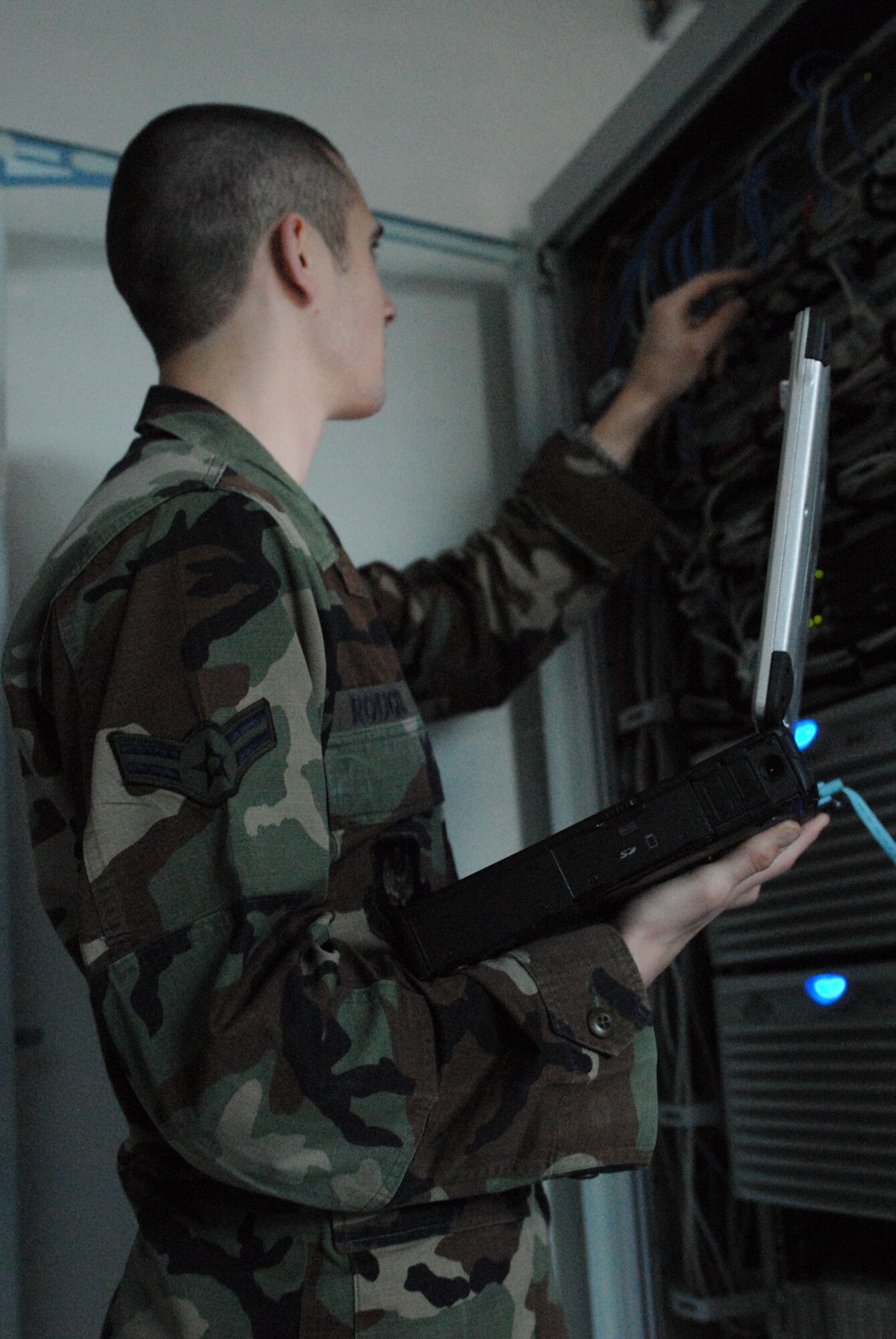 Airman 1st Class Kirk Rodgers inspects a switch on his server at Šiauliai International Airport, Lithuania, Dec 3. Airman Rodgers is part of a team from Ramstein’s 1st Combat Communications Squadron deployed in support of the Baltic Air Police mission. (U.S. Air Force photo by Capt. John Ross)