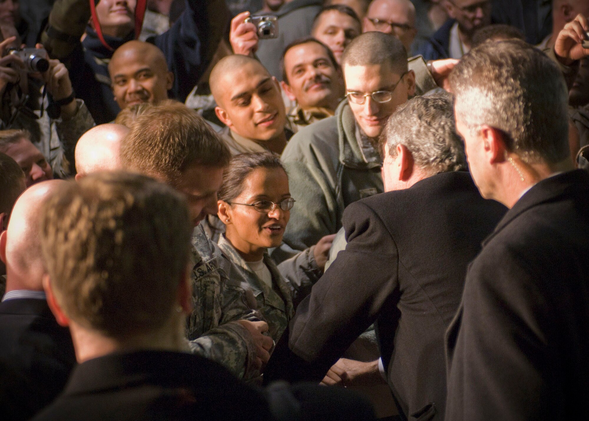President George W. Bush greets Tech. Sgt. Roopa Schoop, a medical technician assigned to the Craig Joint Theater Hospital, and other servicemembers during a visit to Bagram Air Field, Afghanistan, Dec. 15. After thanking them for their service in Afghanistan, President Bush took time individually greet servicemembers and pose for photos. (U.S. Air Force photo by Staff Sgt. Rachel Martinez) (Released)