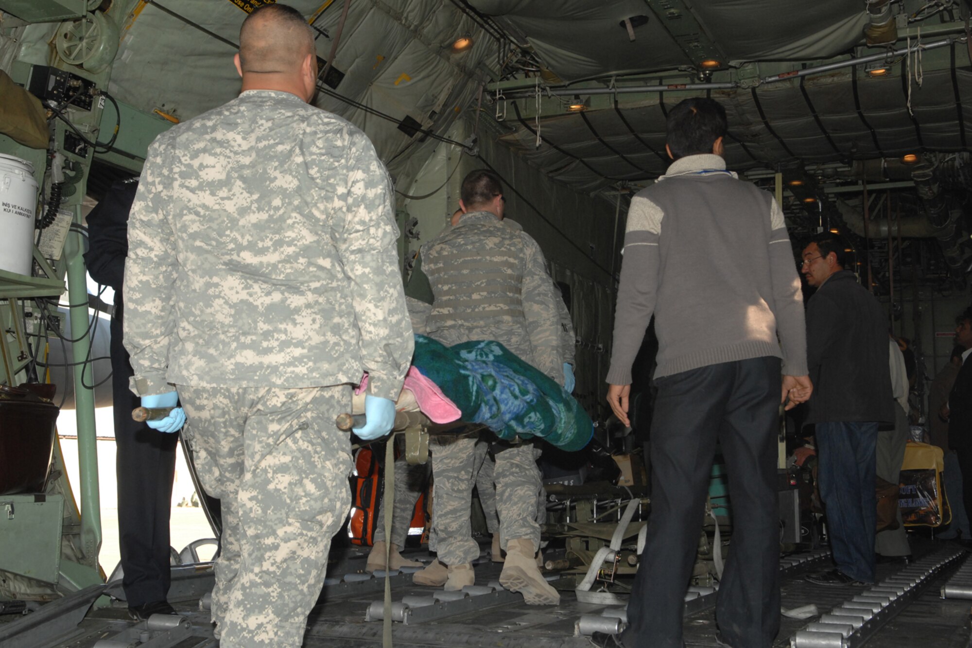 Air Force, Army and local Kirkuk emergency responders help load a patient onto a Turkish C-130 at the Kirkuk Regional Air Base flight line in preparations to fly the patient to Turkey for medical care.  The individual was one of the more than 100 injured when a suicide bomber walked inside a Kurdish restaurant and detonated the explosives killing at least 55 people Dec. 11.  The Iraqi, Turkish and American governments and military worked together to coordinate the C-130 to land at Kirkuk to transport some of the injured. The attack came while the region was celebrating Eid al-Adha, the festive Muslim holiday that comes at the end of the hajj pilgrimage. (U.S. Air Force photo/Senior Airman Randi Flaugh)