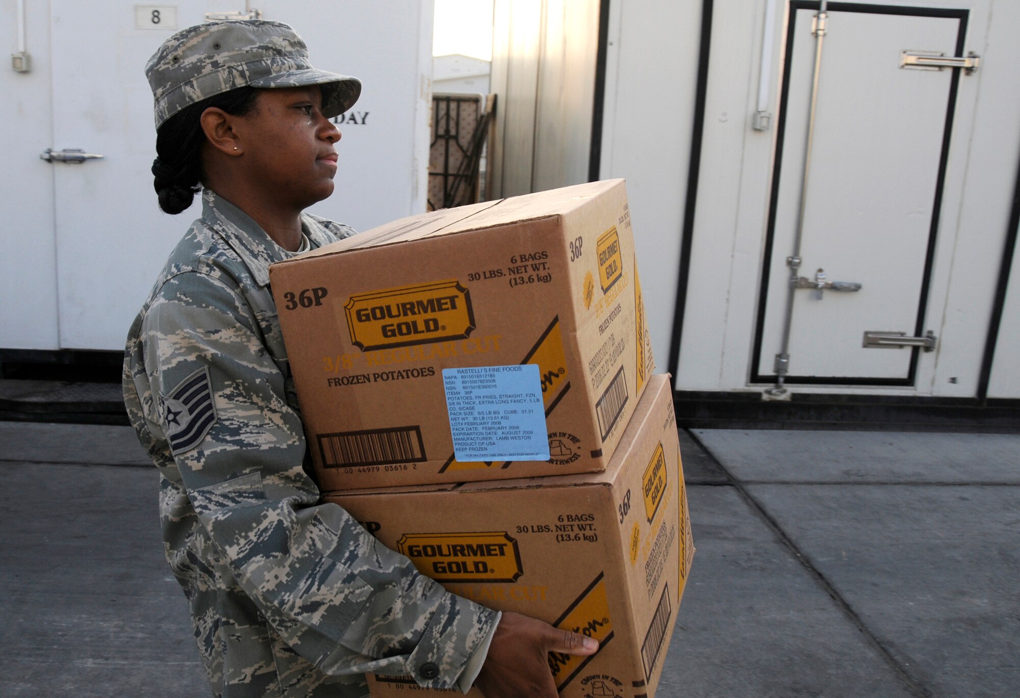 SOUTHWEST ASIA -- Tech. Sgt. Toni Beaty from the 380th Expeditionary Force Support Squadron helps stock frozen foods here. Sergeant Beaty works with other members of EFSS three times a week to offload trucks and stock frozen and dry storage food items. Sergeant Beaty is deployed from the 20th FSS, Shaw Air Force Base, S.C., her hometown is Woodruff, S.C. (U.S. Air Force photo/Tech. Sgt. Christopher A. Campbell)(released)