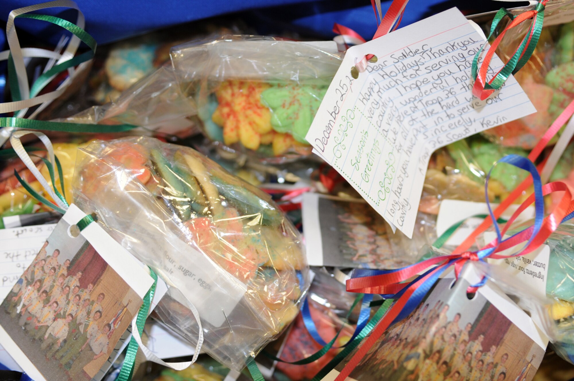 Ian DiFiore, a Boy Scout from NJ, hands out cookies to deployed military members transitioning back to the states at the Contingency Aero-medical Staging Facility as part of his Eagle Scout service project, Ramstein Air Base, Germany Dec. 12. With the help of 35 scouts, over 175 hours have gone into his service project. (U.S. Air Force photo by Senior Airman Kelly LeGuillon)(Released)
