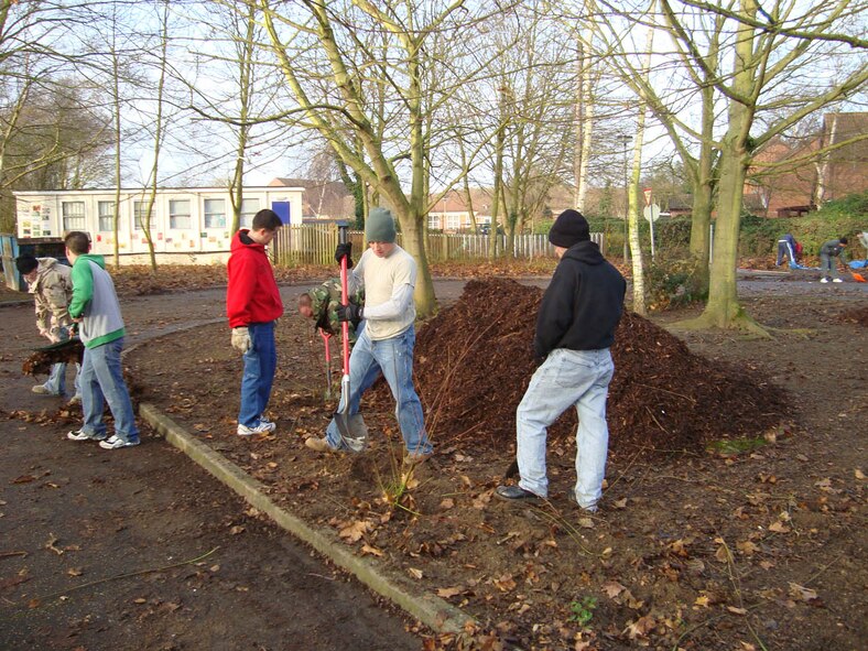 Volunteers from the 95th Reconnaissance Squadron put in 130 man-hours and braved the freezing cold weather Dec. 11, to clear undergrowth, dead and overgrown trees, leaves and rubbish from the exterior grounds of Riverside Middle School, Mildenhall. "The support from members of the U.S. Air Force is invaluable, and it's great to know that our community has so many local supporters," said Caroline Yates, Riverside Middle School headmistress. (U.S. Air Force photo by Chief Master Sgt. John Matthews)                     