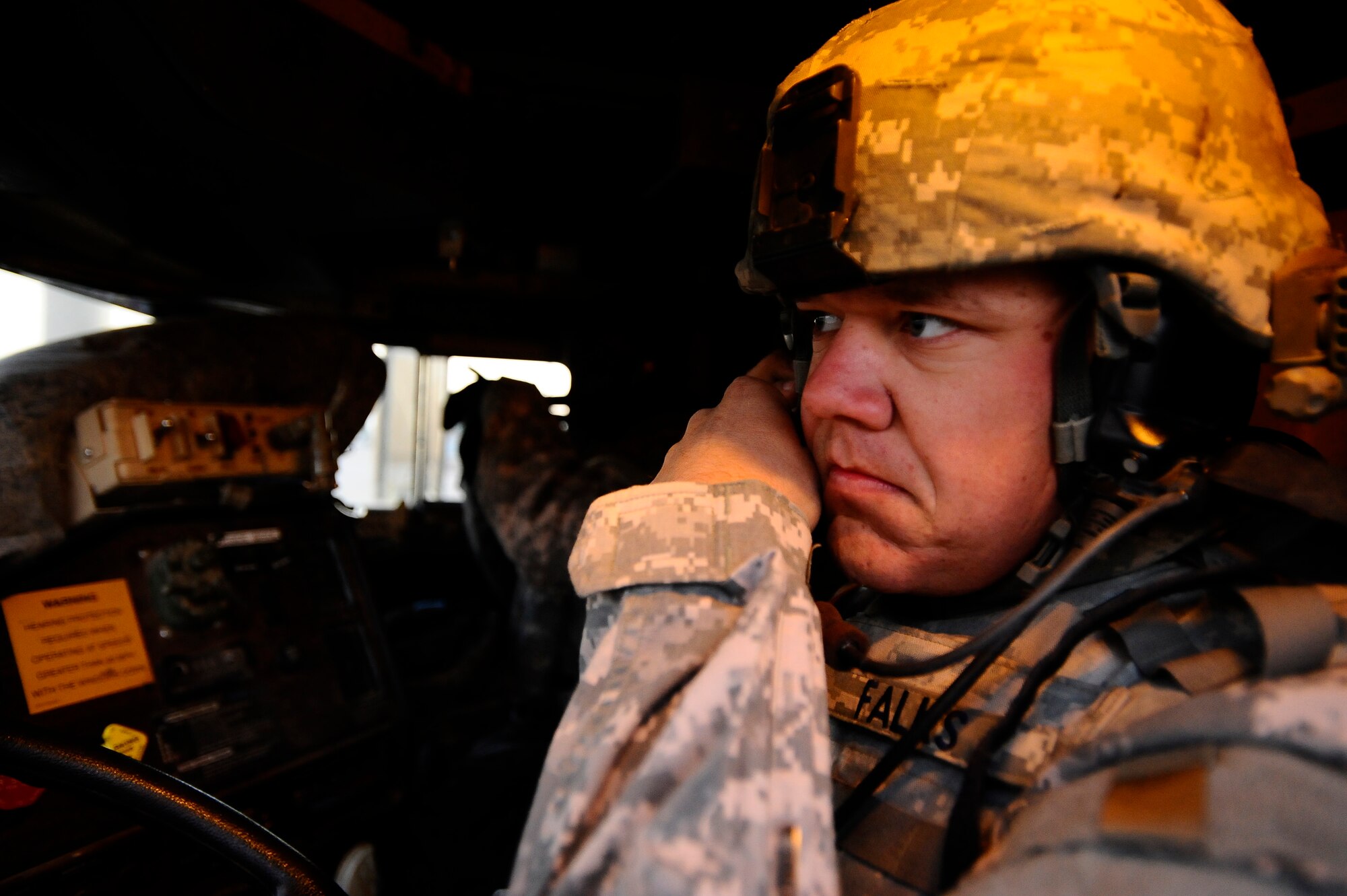 Staff Sgt. Jonathan Falks dons his helmet inside an armored truck at Joint Base Balad, Iraq, Dec. 11. Falks and other Airmen with the 732nd Expeditionary Civil Engineer Squadron Detachment 6 undertake outside-the-wire construction projects for the Army. Falks, a 732nd ECES Det. 6 heavy equipment operator and native of Gonzales, Texas, is deployed from Hickam Air Force Base, Hawaii. (U.S. Air Force photo/Airman 1st Class Jason Epley)