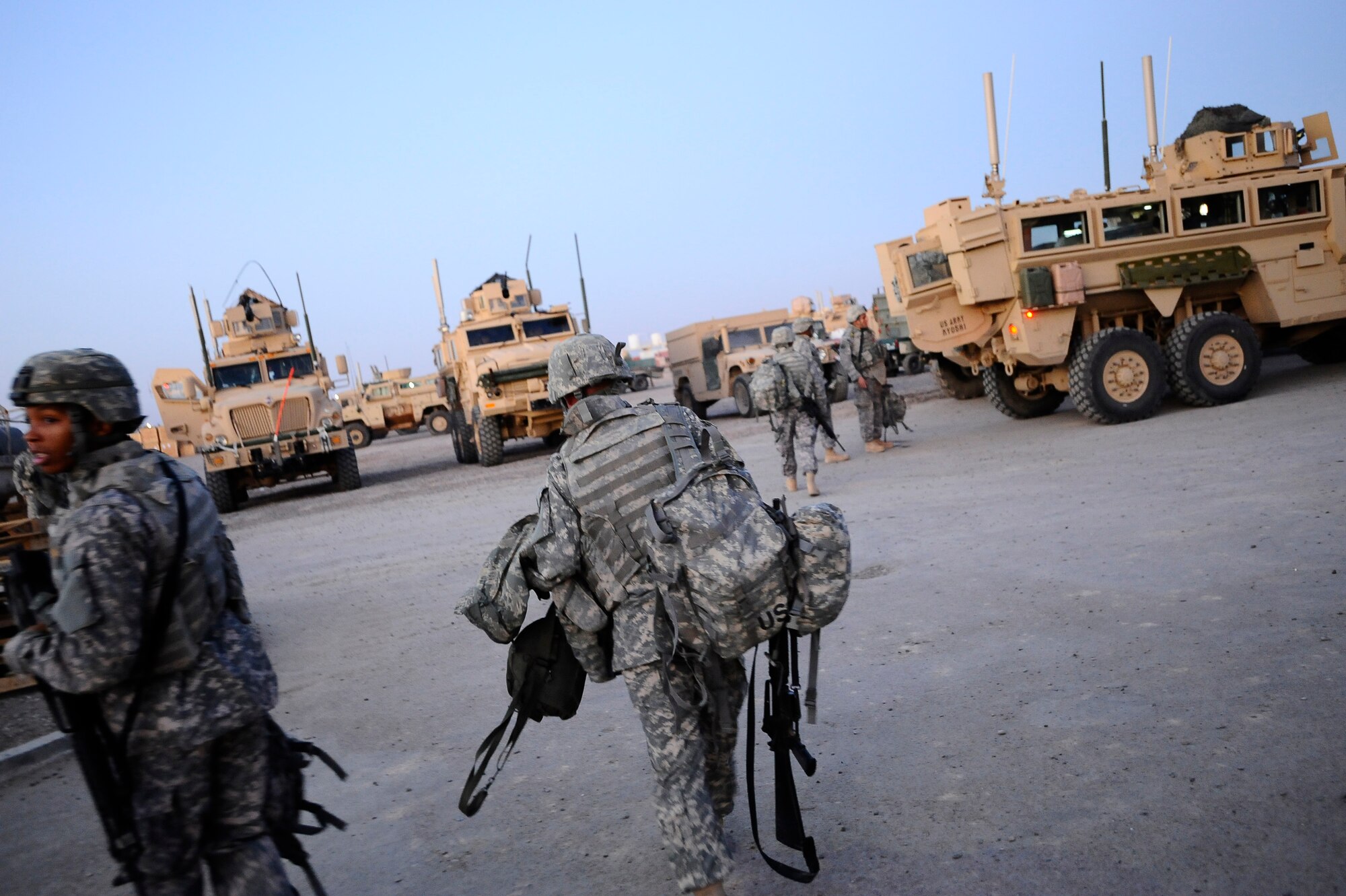 Airmen and Soldiers load into the back of a Mine-Resistant Ambush-Protected vehicle at Joint Base Balad, Iraq, Dec. 11. The Airmen, who are assigned to the 732nd Expeditionary Civil Engineer Squadron Detachment 6, undertake construction projects for the Army, while the Soldiers provide convoy security. (U.S. Air Force photo/Airman 1st Class Jason Epley)