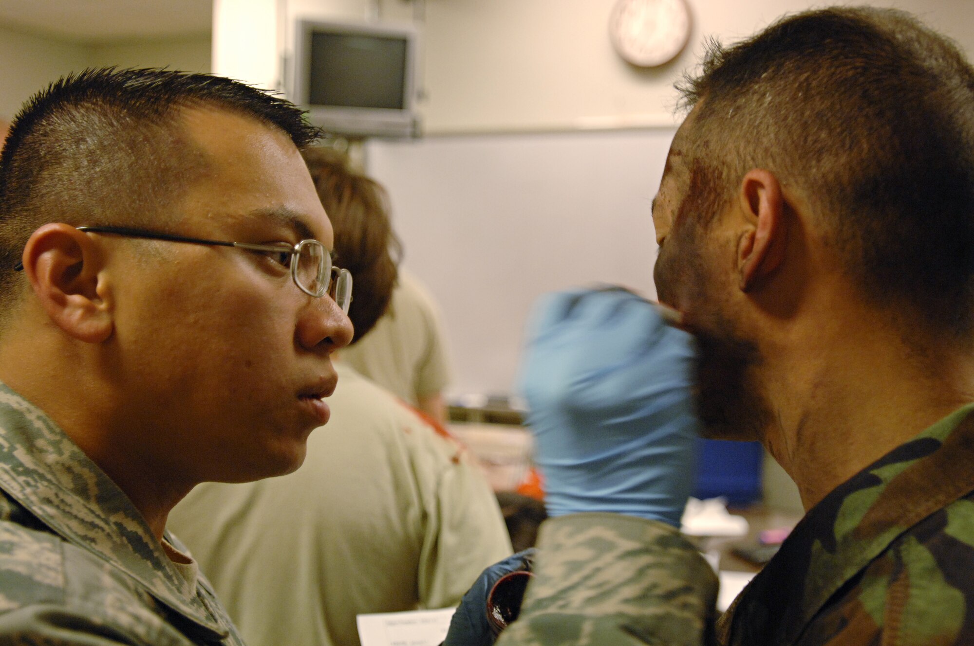 Staff Sgt. David Sui, 39th Medical Operations Squadron, applies makeup to Staff Sgt. Kirt Dicen, 39th Air Base Wing chapel, who is acting as a burn victim in the major accident response exercise, Dec. 12. The 39 ABW performs a MARE quarterly to help Airmen prepare for real world contingnencies. (U.S. Air Force photo by Senior Airman Benjamin Wilson)