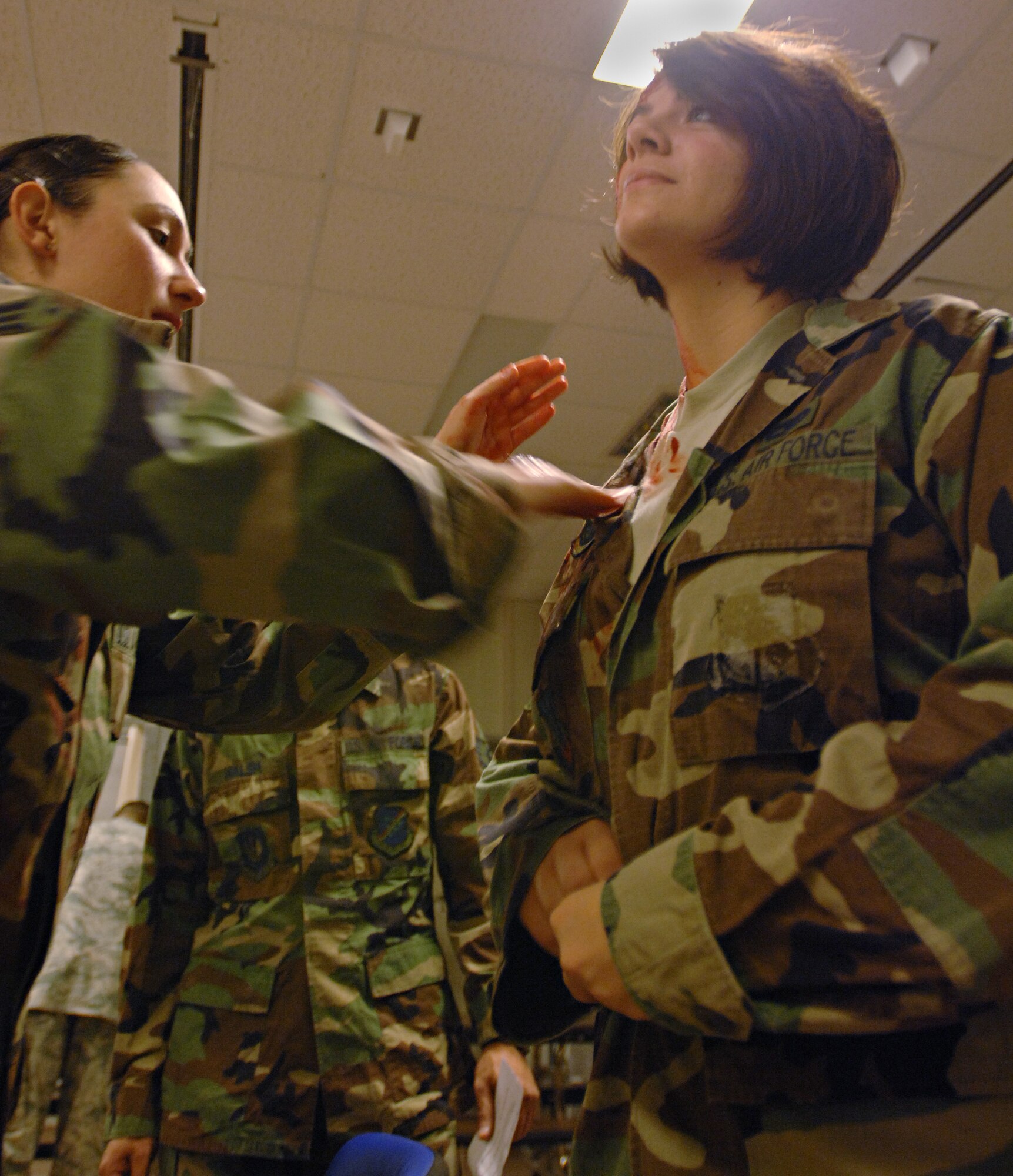 Senior Airman Erica Stewart, 39th Air Base Wing Public Affairs, applies fake blood to Airman 1st Class Amber Russell, 39 ABW PA, while preparing to act as victims for a major  accident response exercise, Dec 12. The 39 ABW performs a MARE quarterly to help Airmen prepare for real world contingnencies. (U.S. Air Force photo by Senior Airman Benjamin Wilson)