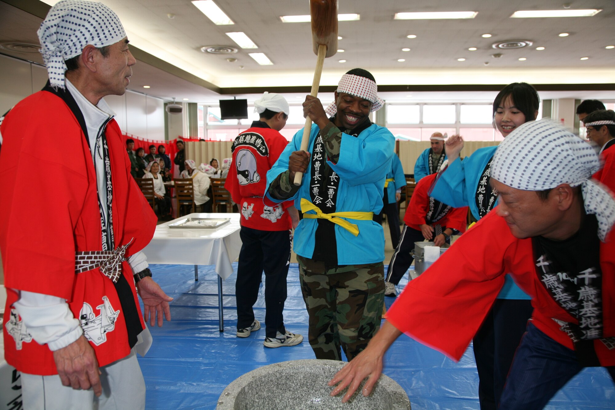 Senior Master Sgt. Tony Mills, 13th Air Force, Detachment 1, superintendent
and ATR lead logistics planner, takes a turn pounding rice during a
traditional Japanese New Year Mochitsuki ceremony at Japan Air Self-Defense
Force's Chitose Air Base Dec. 12. Sergeant Mills and approximately 70 Airmen
from the 18th Wing participated in a bilateral training event with the
JASDF's 2nd Air Wing as part of the Aviation Training Relocation program. 
(Courtesy photo)
