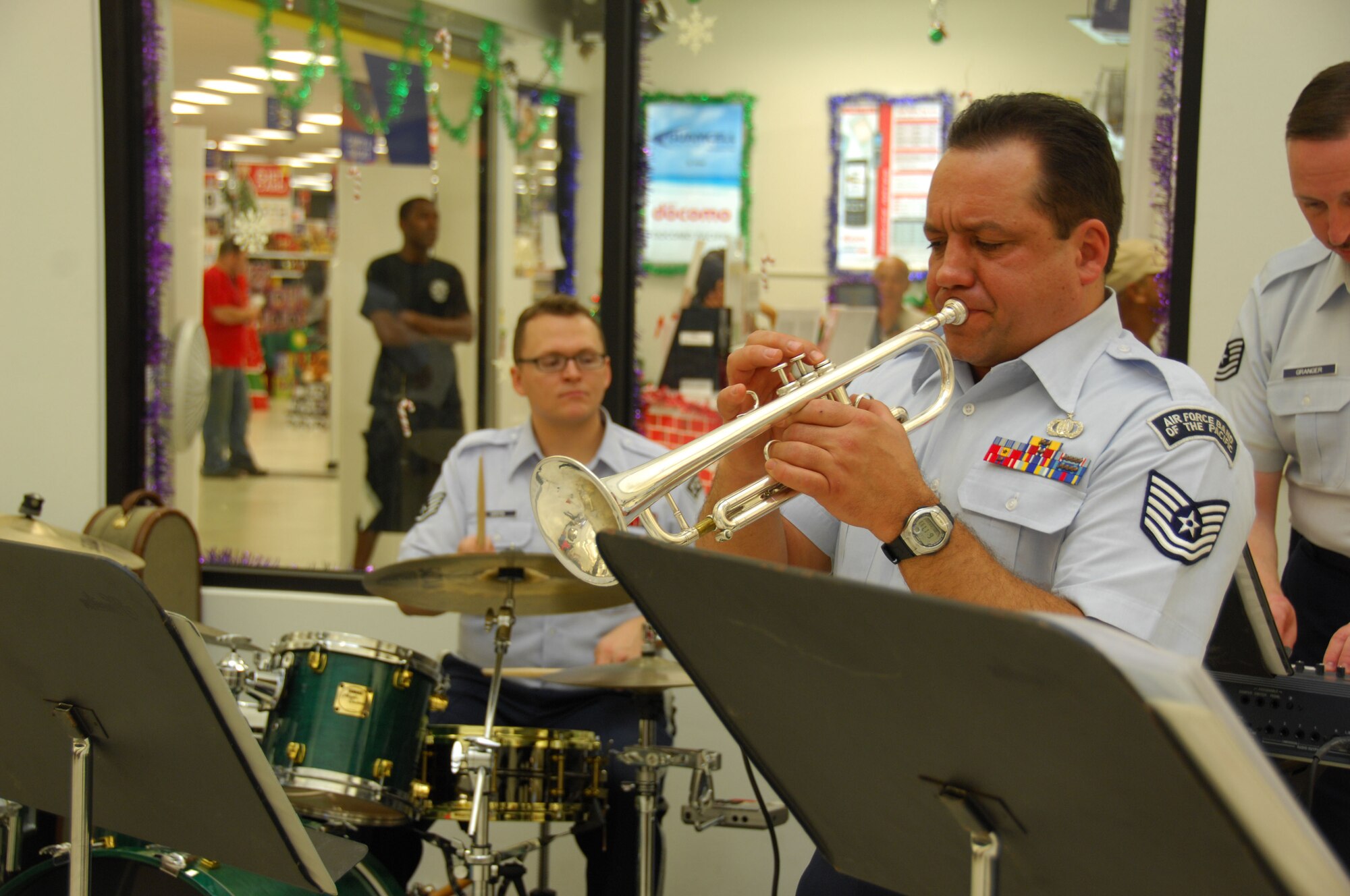 ANDERSEN AIR FORCE BASE, Guam - Tech. Sgt. Sam Cliff, Alaska Brass NCO-in-charge, plays trumpet during a performance at the Base Exchange here Dec. 15. Air Force bands promote esprit de corps, while fostering community relations and projecting a positive Air Force image. (U.S. Air Force photo by Senior Airman Jonathan Hart)