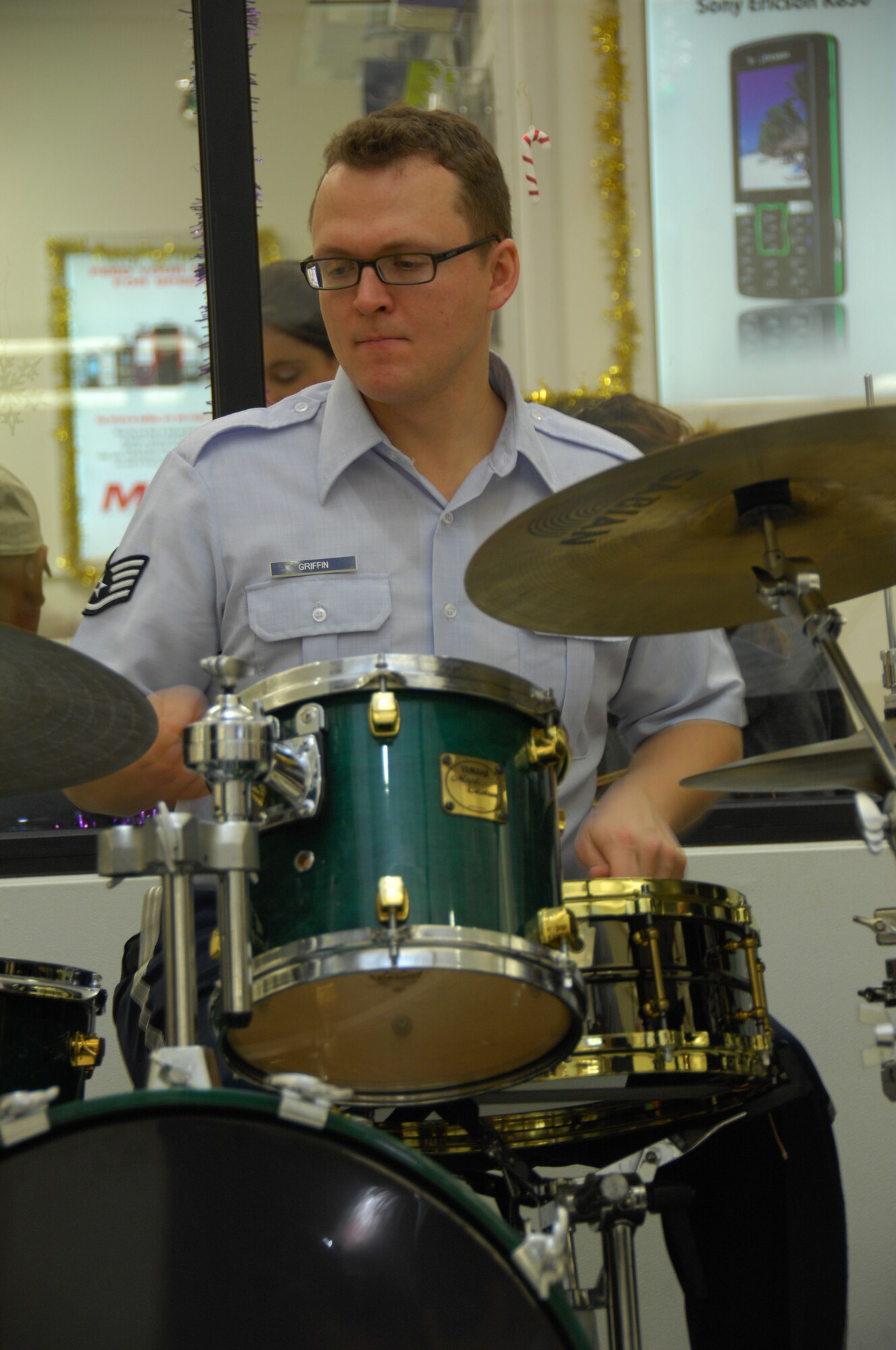 ANDERSEN AIR FORCE BASE, Guam - Staff Sgt. Troy Griffin, drummer for the Alaska Brass, performs a one-hour set of holiday music at the Base Exchange here Dec. 15. The Alaska Brass is a five-piece brass and percussion ensemble stationed at Elmendorf Air Force Base, Alaska. (U.S. Air Force photo by Senior Airman Jonathan Hart)