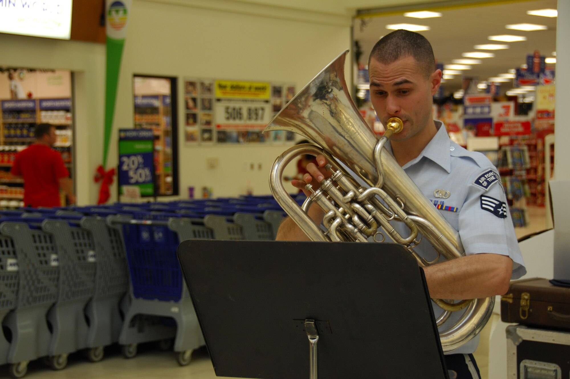 ANDERSEN AIR FORCE BASE, Guam - Senior Airman George Father from the Band of the Pacific's Alaska Brass, plays the French horn during a performance at the Base Exchange here Dec. 15. This was the first performance on the Alaska Brass' tour of Guam. (U.S. Air Force photo by Senior Airman Jonathan Hart)