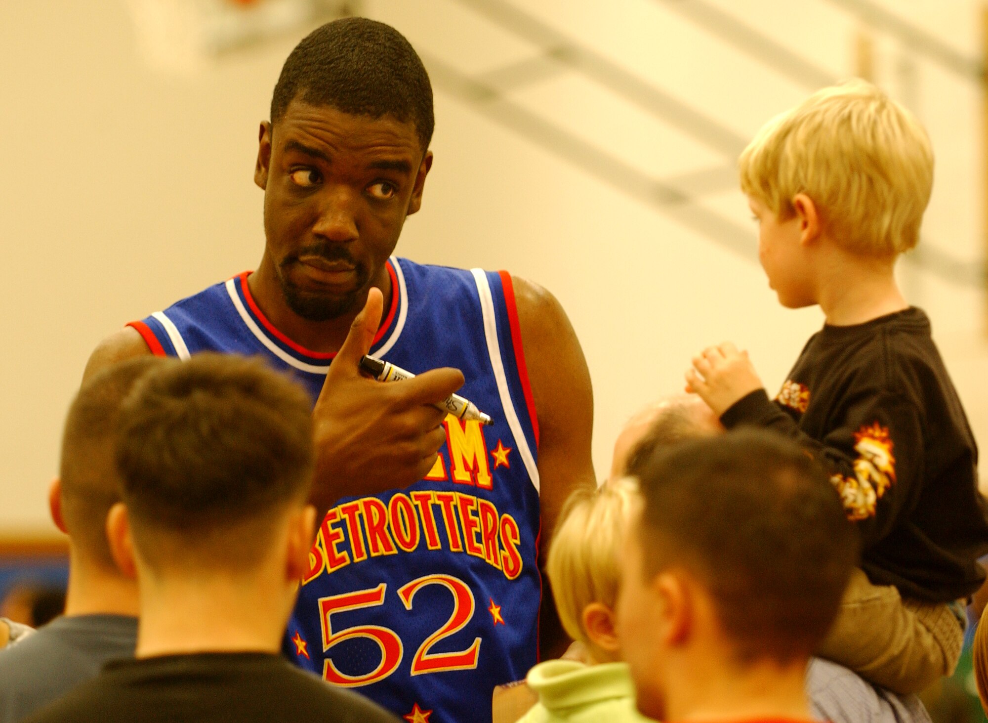 Big Easy Lofton, a Harlem Globetrotter, gives a thumbs-up to a fan during an autograph signing session Dec. 12 at the Risner Fitness Center here. The Globetrotters team have played in 120 countries around the world.
(U.S. Air Force official photo/Staff Sgt. Nestor Cruz)