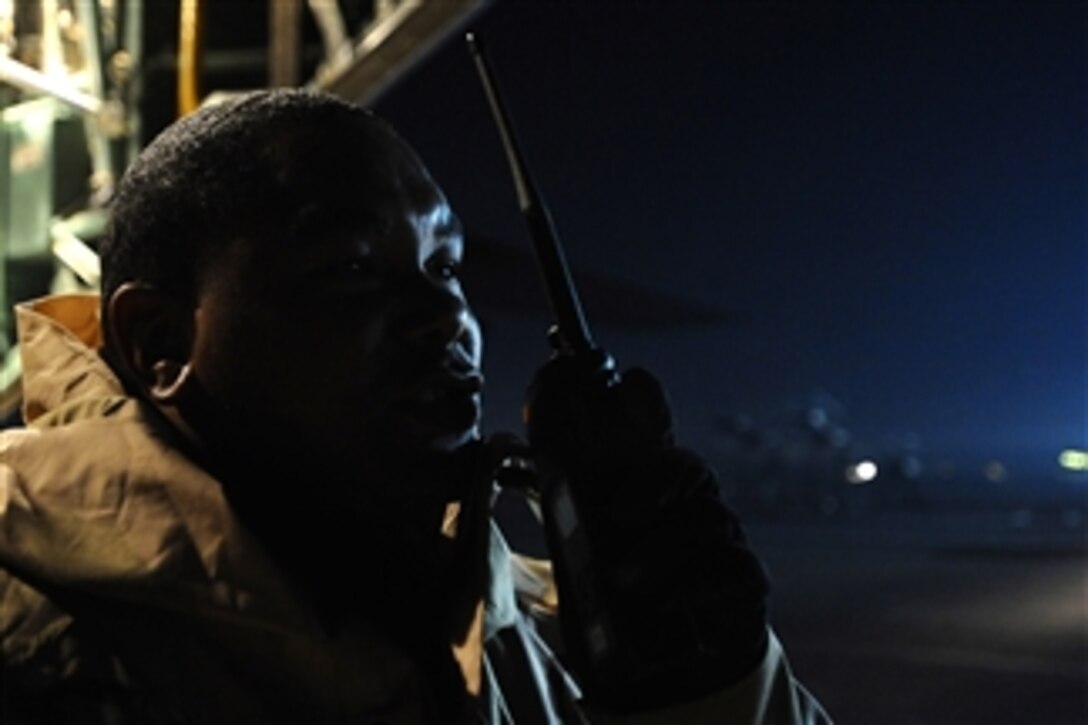 U.S. Air Force Master Sgt. Chuck Knight radios instructions for loading registered mail while on the flight line at Joint Base Balad, Iraq, on Dec. 14, 2008.  Knight is the noncommissioned officer-in-charge of special cargo for the 332nd Expeditionary Logistics Readiness Squadron.  