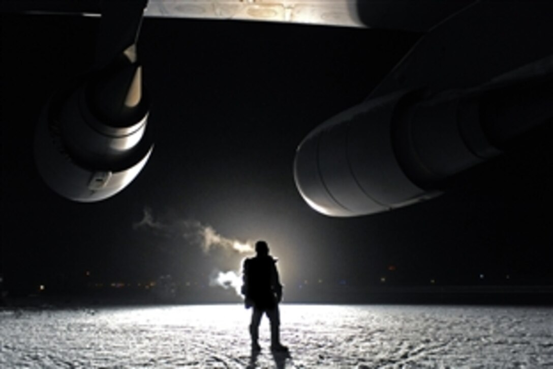 U.S. Air Force Master Sgt. Jorge Orama checks for leaks on a C-5M Super Galaxy engine after the aircraft sat outside for more than 24 hours in temperatures low as -25 degrees during a cold weather test on Eielson Air Force Base, Alaska, Dec. 14, 2008. Orama is assigned to the Air Mobility Command Test and Evaluation Squadron, Detachment 1 at Edwards Air Force Base, Calif.  