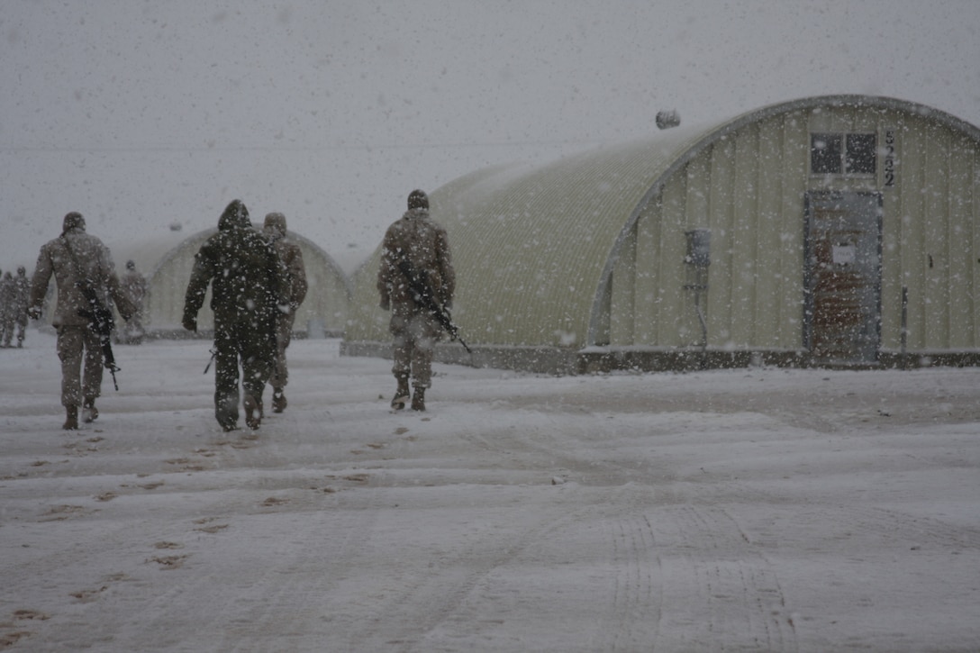 Marines at the Combat Center’s Camp Wilson make their way through snow to get back to their K-Span berthing spaces Wednesday, Dec. 17, 2008, during a snow storm which hit the entire Morongo Basin.