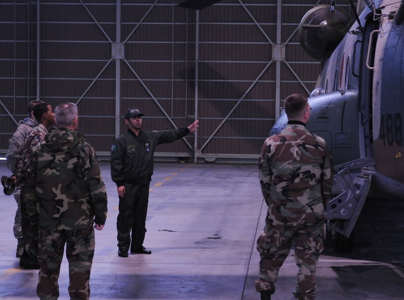 YOKOTA AIR BASE, Japan - Capt. Myazoato, a CH-47J helicopter pilot from the Japanese Air Self Defense Force briefs members of Yokota's 374th Maintenance Group on the capabilities of the CH-47J helicopter Dec. 17. The 374th Airlift Wing and JASDF participate in these events to find out how each operates and maintains their aircraft. (U.S. Air Force photo by Airman Devin Doskey)