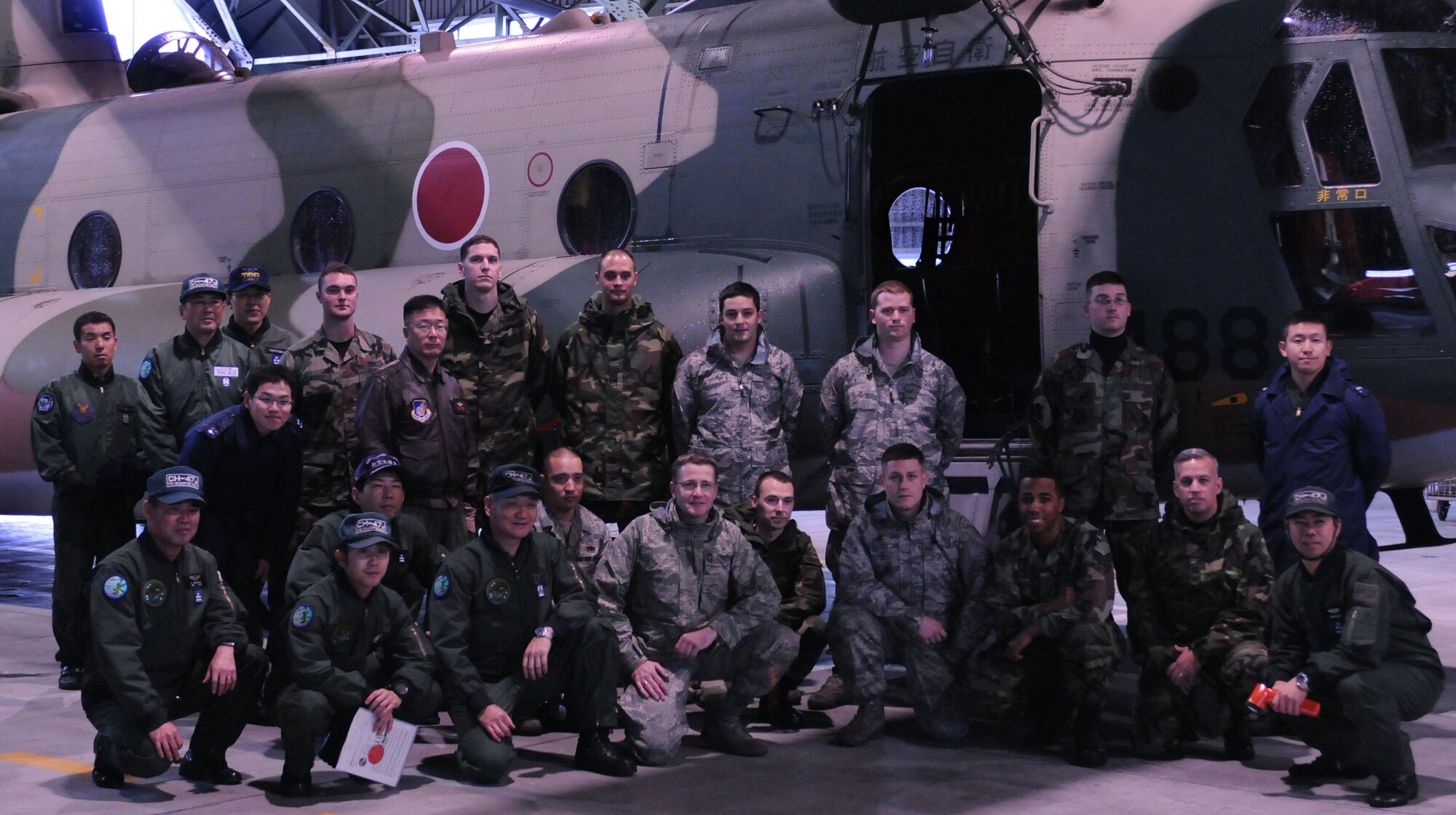 YOKOTA AIR BASE, Japan- Members of Yokota's 374th Maintenance Group and the Japanese Air Self Defense Force pose for a group photo in front of a CH-47J helicopter Dec. 17 at Iruma Air Base. Members of the 374th Airlift Wing and Japanese Air Self Defense Force participate in these bilateral events once a quarter to build understanding between their cultures. (U.S. Air Force photo by Airman Devin Doskey)  
