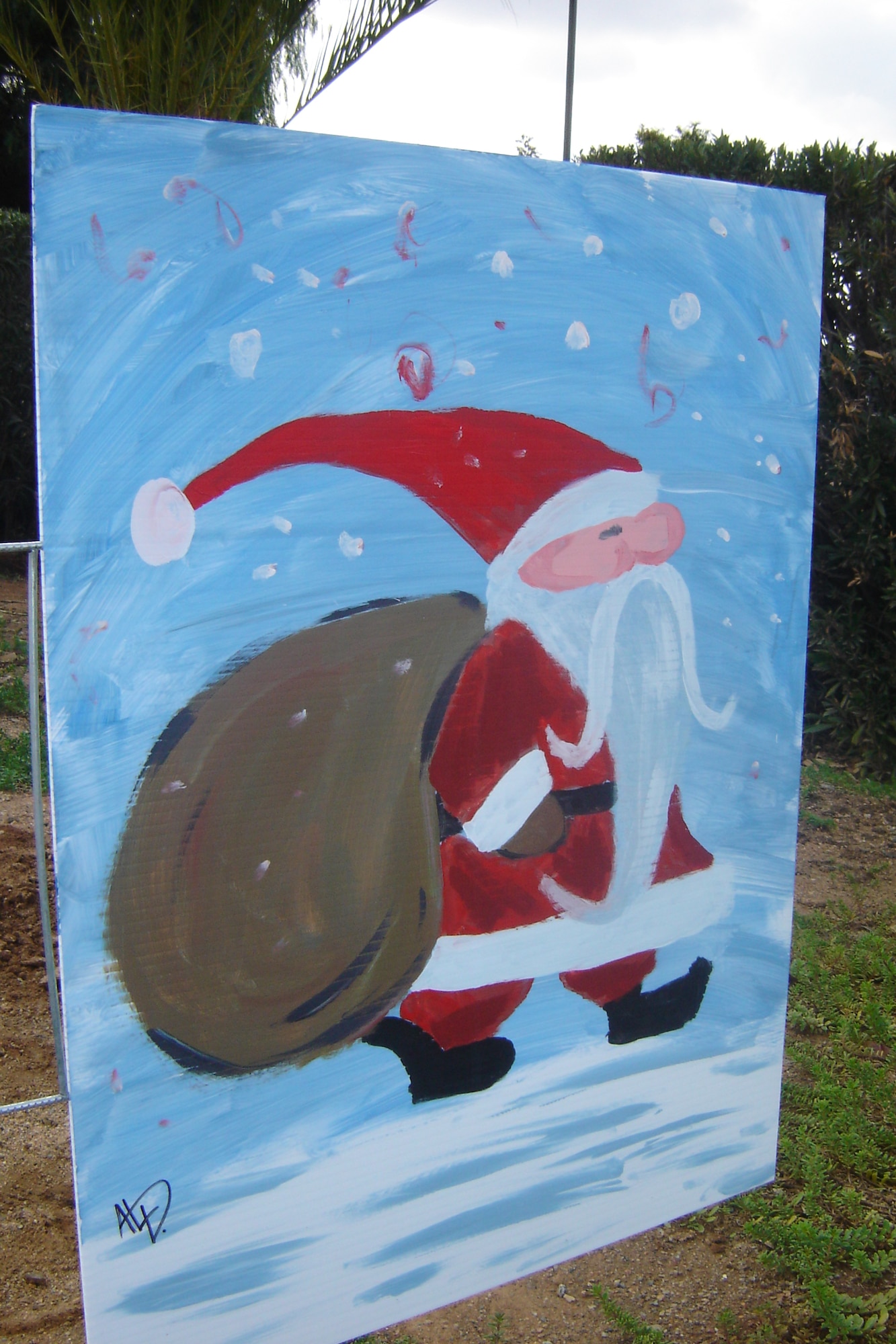 Staff Sgt. Al Dupont, 163 RW/ SVF, was the first to paint one of two pictures now displayed on Holiday Card Lane near the Main Gate. (U.S Air Force photo by Will Alexander)