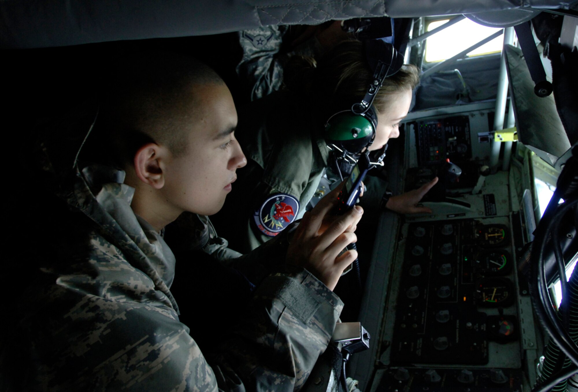 MCCONNELL AIR FORCE BASE, Kan. – Airman Sean Richardson, 22nd Aircraft
Maintenance Squadron, photographs a refueling mission while abaord a KC-135 Stratotanker, Dec. 11, during an incentive flight for Airmen from the First Term Airmen Center. The tanker refueled a B-52 Stratofortress and a B-2 Spirit during the mission.(Photo by Senior Airman Laura Suttles)

