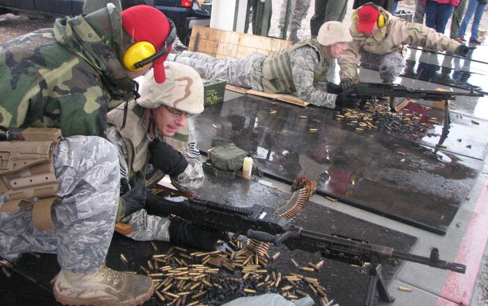 The 99th Security Forces Combat Arms section show the commanders, chiefs and spouses the training each Airman receives in handling a weapon before being deployed during a demonstration at the 57th Wing Commanders Conference.The conference gathered 57th Wing leadership and their spouses to promote teamwork and show how each squadron works together as one in accomplishing the wing’s mission.(U.S. Air Force photo by Capt. Oren Goldstein)