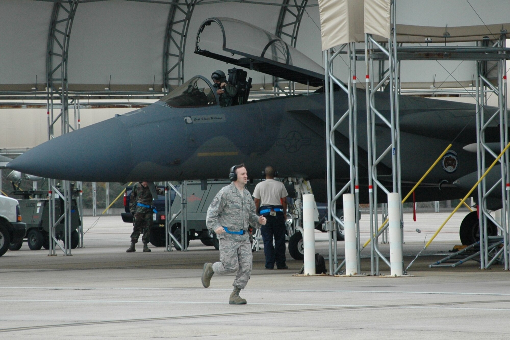 Master Sgt. Shay Thigpen, 58th Aircraft Maintenance Unit, hastily moves to and from F-15 Eagles preparing for take-off in simulated alert status Dec. 17. As the pro-super, Sergeant Thigpen, oversaw all maintenance operations, ensuring jets were prepped safely and to standard by 33rd Fighter Wing maintainers during a week-long wing exercise. Practicing how to “scramble” provided beneficial training to the Nomads who can be called up to support an Air Force Operation Noble Eagle tasking at a moment’s notice. (U.S. Air Force photo/Chrissy Cuttita)