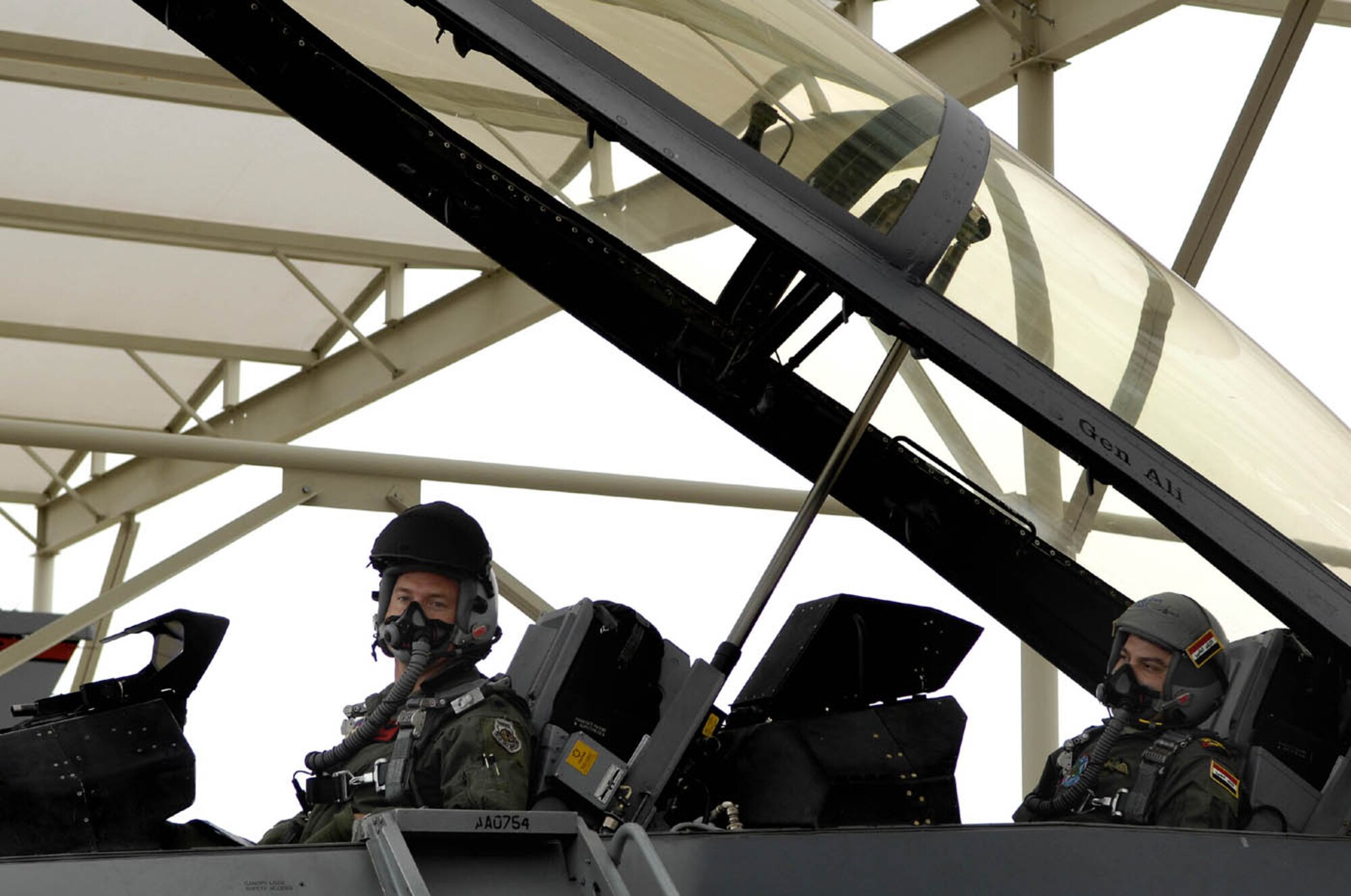 Lt Col Jack Maixner, commander of the 63rd Fighter Squadron at Luke Air Force Base, Arizona and Iraqi Air Force Brig Gen Ali Al-Aaragy make final preparations before their flight together on December 15, 2008 at Luke AFB.  (Photo by U.S. Air Force Staff Sgt Richard Rose)
