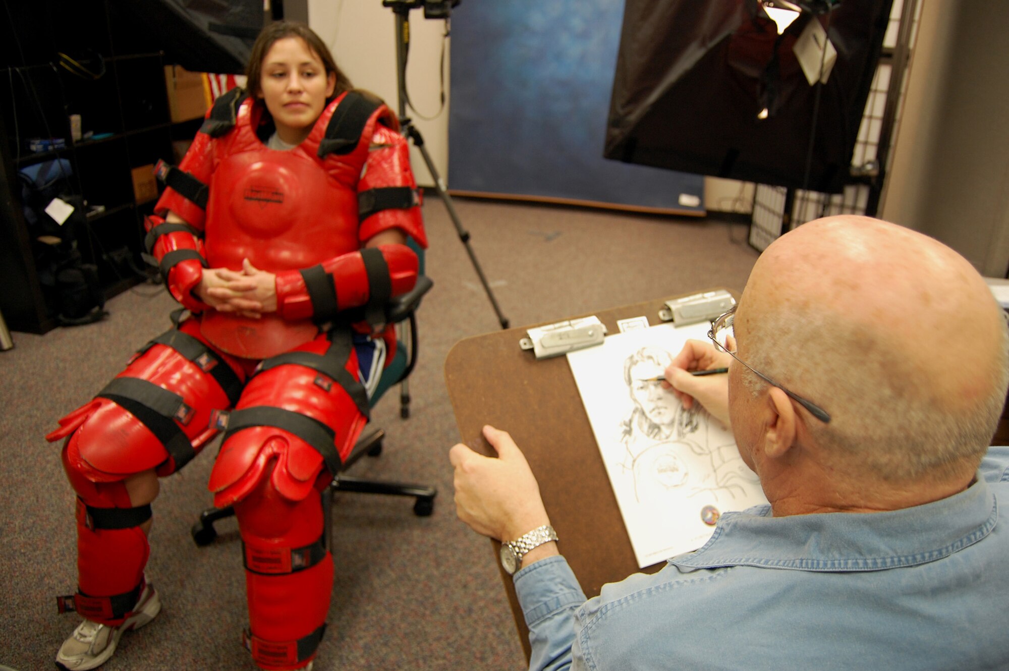 Artist John Witt, chairman of the New York Society Illustrators, sketches Staff Sgt. Lucinda Jenkins, security forces contingency skills instructor with the U.S. Air Force Expeditionary Center's 421st Combat Training Squadron, Dec. 11, 2008, in the Expeditionary Center studio on Fort Dix, N.J.  The effort was part of preparatory work by an Mr. Witt to complete a painting highlighting Expeditionary Center Airmen for the Air Force Art Program.  (U.S. Air Force Photo/Tech. Sgt. Scott T. Sturkol)
