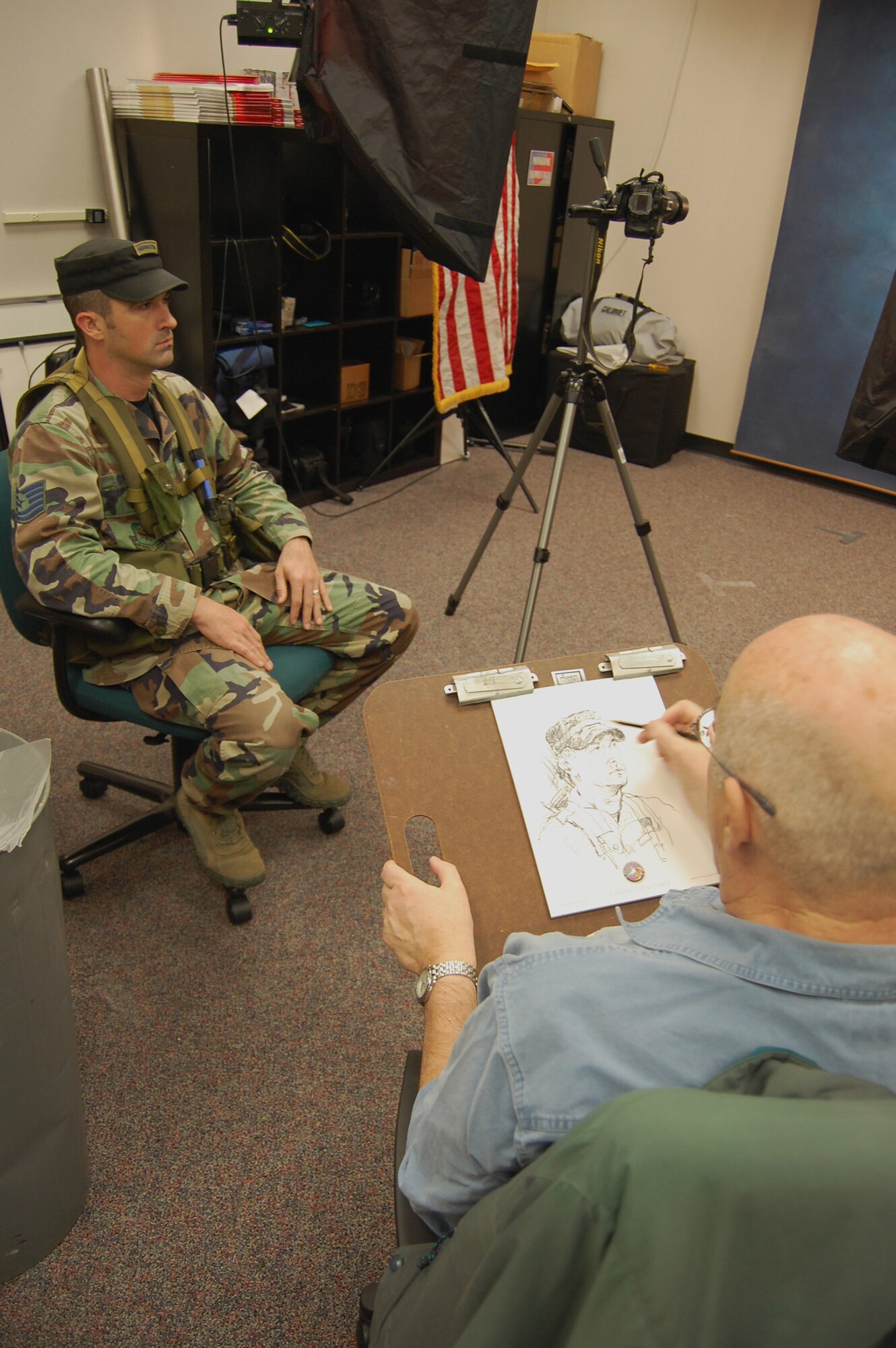 Artist John Witt, chairman of the New York Society Illustrators, sketches Tech. Sgt. Sean Graves, contingency skills instructor with the U.S. Air Force Expeditionary Center's 421st Combat Training Squadron, Dec. 11, 2008, in the Expeditionary Center studio on Fort Dix, N.J.  The effort was part of preparatory work by an Mr. Witt to complete a painting highlighting Expeditionary Center Airmen for the Air Force Art Program.  (U.S. Air Force Photo/Tech. Sgt. Scott T. Sturkol)
