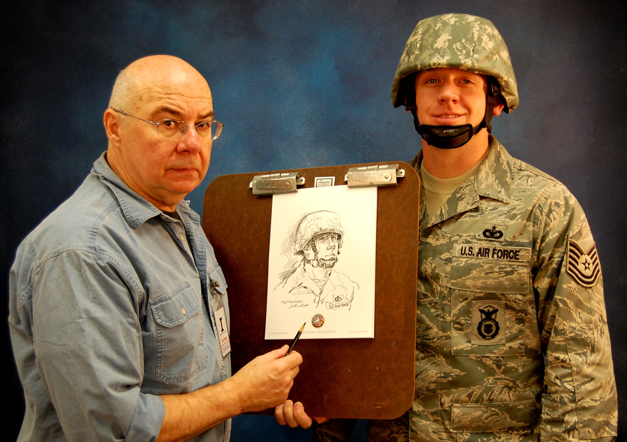 Artist John Witt, chairman of the New York Society Illustrators, stands with Tech. Sgt. Ryan Thompson, security forces contingency skills instructor with the U.S. Air Force Expeditionary Center's 421st Combat Training Squadron, and a sketch of Sergeant Thompson Dec. 11, 2008, in the Expeditionary Center studio on Fort Dix, N.J.  The effort was part of preparatory work by an Mr. Witt to complete a painting highlighting Expeditionary Center Airmen for the Air Force Art Program.  (U.S. Air Force Photo/Tech. Sgt. Scott T. Sturkol)