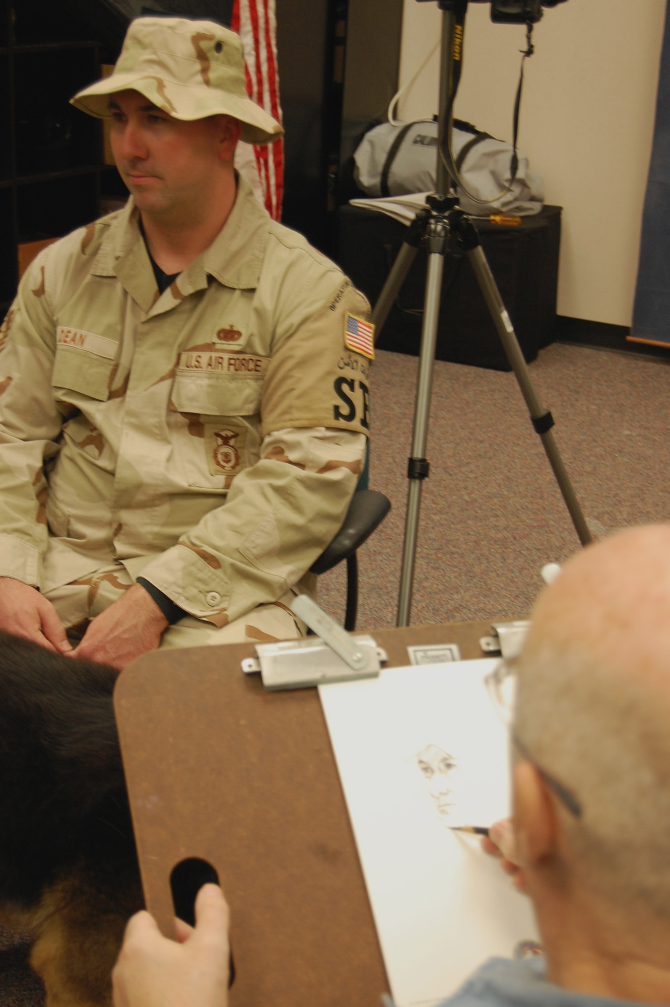 Artist John Witt, chairman of the New York Society Illustrators, sketches Tech. Sgt. Jeff Dean, security forces contingency skills instructor with the U.S. Air Force Expeditionary Center's 421st Combat Training Squadron, Dec. 11, 2008, in the Expeditionary Center studio on Fort Dix, N.J.  The effort was part of preparatory work by an Mr. Witt to complete a painting highlighting Expeditionary Center Airmen for the Air Force Art Program.  (U.S. Air Force Photo/Tech. Sgt. Scott T. Sturkol)