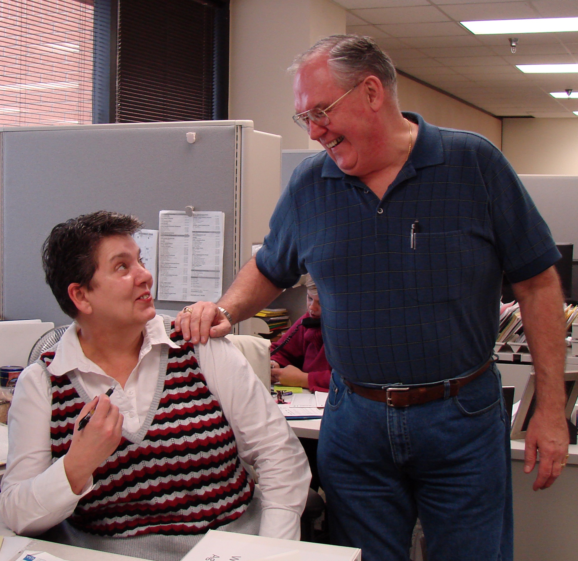 Work resumed in the 71st Comptroller-Contractor Squadron after Mr. David Gindlesberger, right, saved Ms. Rose Palacios from choking on a piece of candy Dec. 5 by using the Heimlich maneuver. (U.S. Air Force photo by 2nd Lt. Lynn Aird)