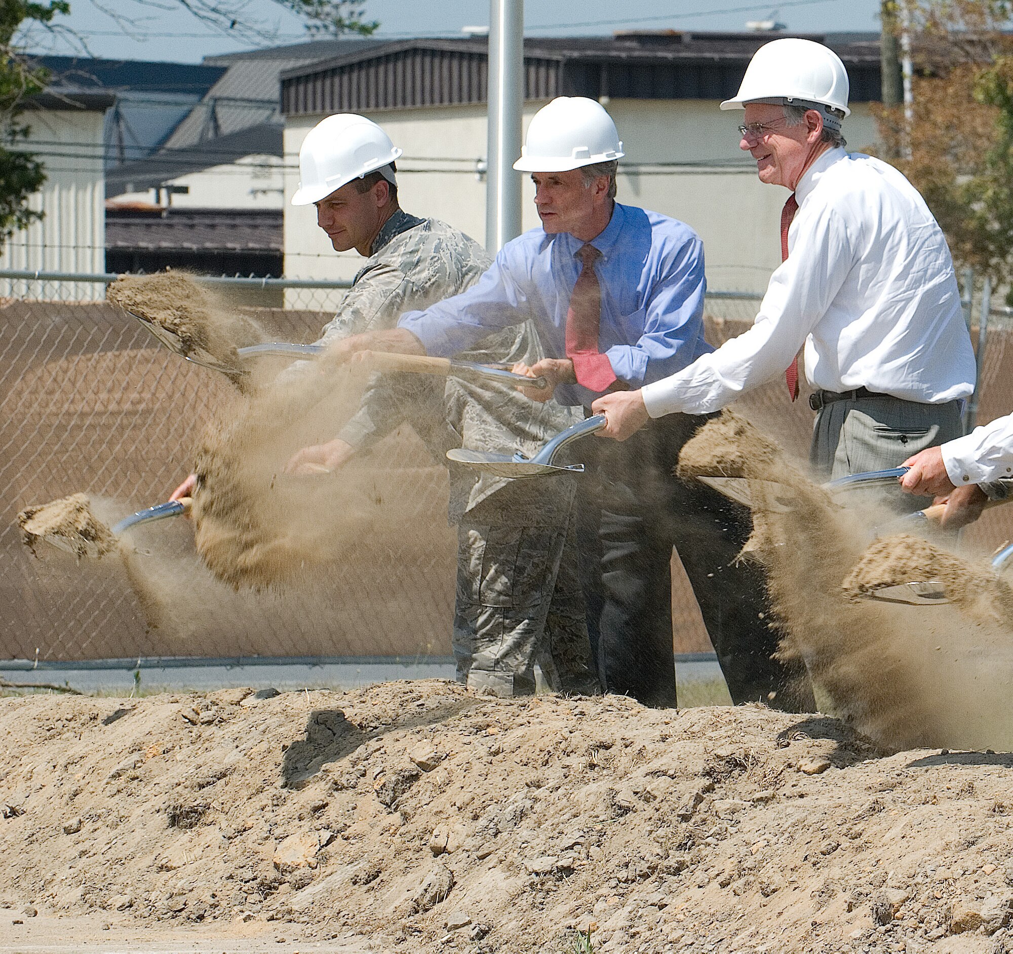(Left to right) Col. Steven Harrison, 436th Airlift Wing commander, U.S. Senator Thomas Carper, U.S. Rep. Mike Castle, dig in their shovels July 21 to officially break ground on Dover's newest dormitory.  The $14 million four-person apartment-style dormitory is scheduled for completion in Spring 2010.  (U.S. Air Force photo/Roland Balik)