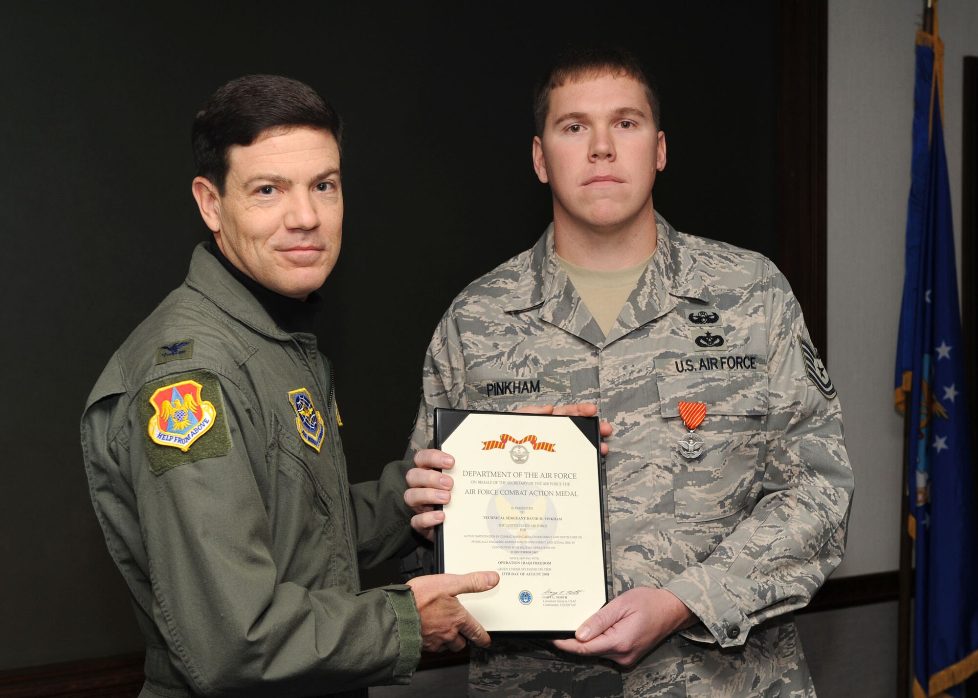 SCOTT AIR FORCE BASE, Ill. -- Col. Stephen Oliver, 375th Airlift Wing vice commander, presents the Air Force Combat Action Medal to Tech. Sgt. Manuel J. Herrera Jr. and Tech. Sgt. David M. Pinkham, 375th Civil Engineer Squadron Explosive Ordinance Disposal flight craftsman, for bravery under fire. Sergeants Herrera and Pinkham were attacked while on convoy missions in support of Operation Enduring Freedom. (U.S. Air Force photo/Senior Airman Jonathan Lovelady)