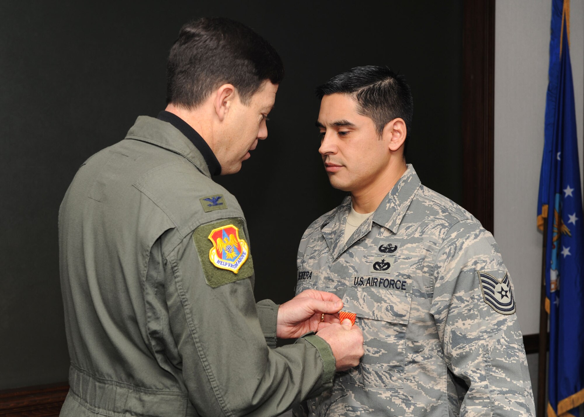 SCOTT AIR FORCE BASE, Ill. -- Col. Stephen Oliver, 375th Airlift Wing vice commander, presents the Air Force Combat Action Medal to Tech. Sgt. Manuel J. Herrera Jr. and Tech. Sgt. David M. Pinkham, 375th Civil Engineer Squadron Explosive Ordinance Disposal flight craftsman, for bravery under fire. Sergeants Herrera and Pinkham were attacked while on convoy missions in support of Operation Enduring Freedom. (U.S. Air Force photo/Senior Airman Jonathan Lovelady)