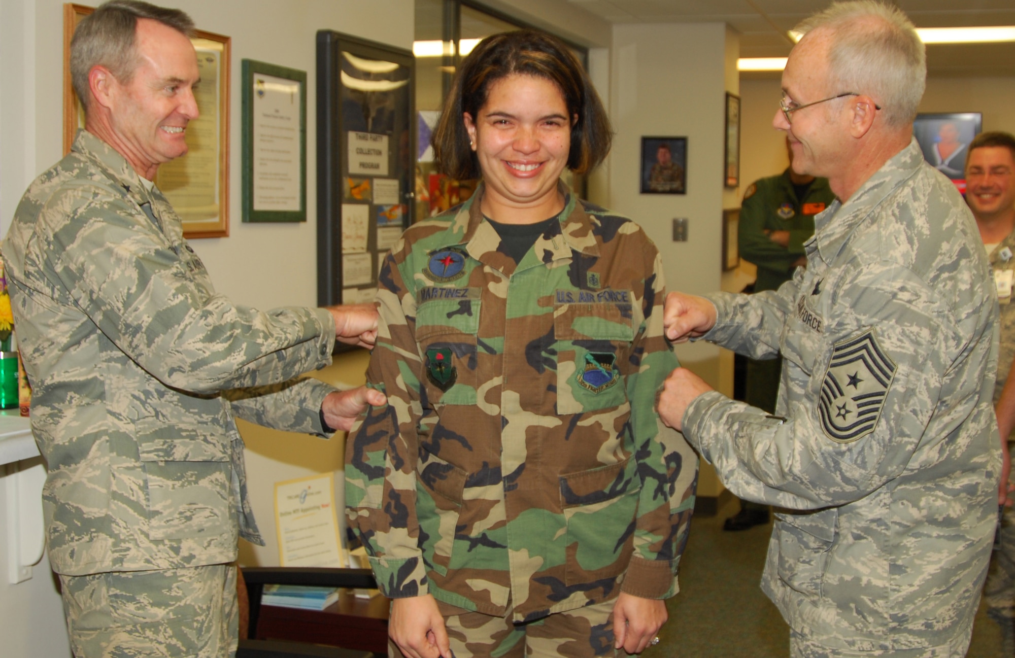 Tech. Sgt. Nicol Martinez, 325th Medical Support Squadron diagnostic imaging craftsman, receives a STEP promotion to the rank of technical sergeant from 325th Fighter Wing Commander, Brig. Gen. Darryl Roberson, and Chief Master Sgt. Benjamin Van Vleet, 325th FW command chief master sergeant, here today.  (U.S. Air Force photo/Lisa Norman)