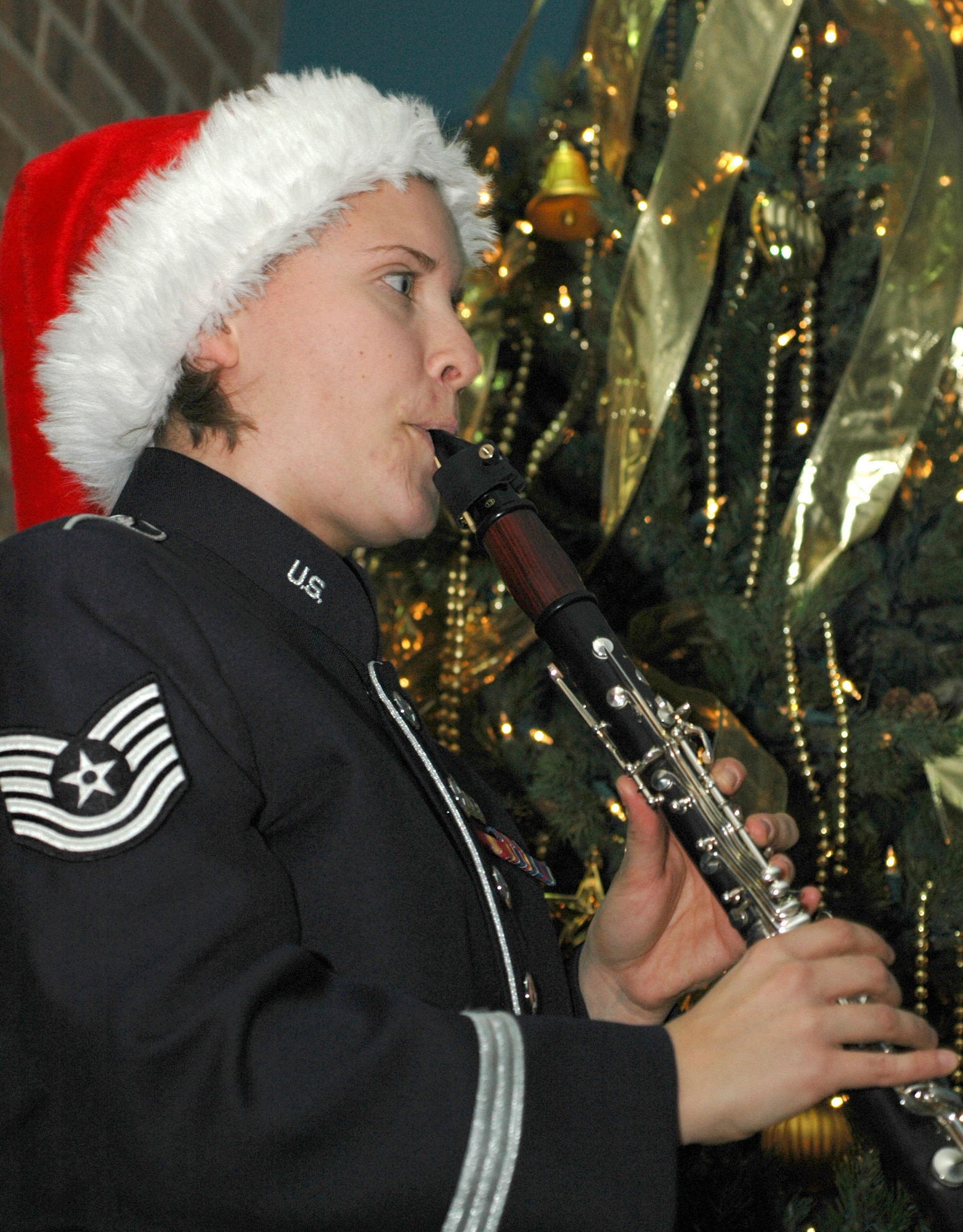 Tech. Sgt. Laura Bardill supplies a little bit of seasonal spirit with her clarinet playing Dec. 17, 2008, in the 302nd Airlift Wing headquarters building on Peterson Air Force Base in Colorado. Sergeant Bardill is a member of the U.S. Air Force Academy band. (U.S. Air Force photo/Stephen J. Collier)