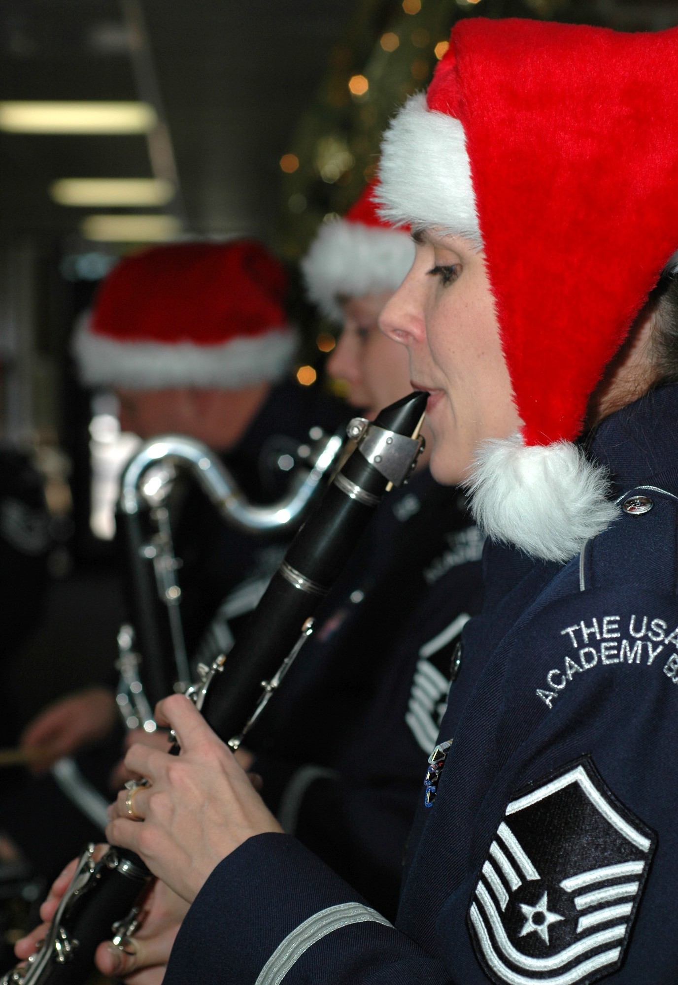 Together with other members of the U.S. Air Force Academy band, Master Sgt. Noelle Little toots her clarinet for 302nd Airlift Wing members Dec. 17, 2008, with a holiday music ensemble in the wing's headquarters building on Peterson Air Force Base in Colorado.(U.S. Air Force photo/Stephen J. Collier)