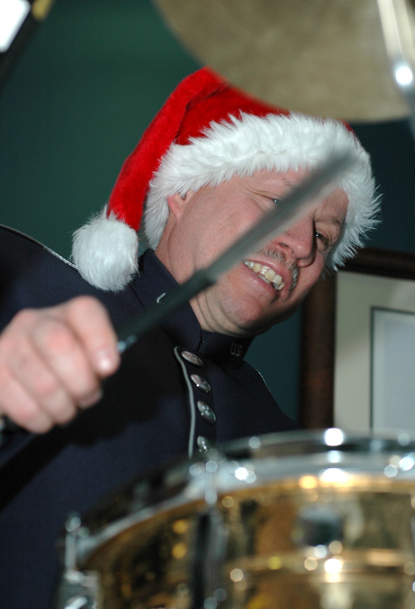 Chief Master Sgt. Scott Barbier bangs out the sounds of the holiday season for members of the 302nd Airlift Wing Dec. 17, 2008, with a holiday music ensemble in the wing's headquarters building on Peterson Air Force Base in Colorado. Chief Barbier is a member of the U.S. Air Force Academy band. (U.S. Air Force photo/Stephen J. Collier)