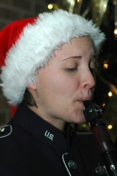 Tech. Sgt. Laura Bardill supplies a little bit of seasonal spirit with her clarinet playing Dec. 17, 2008, in the 302nd Airlift Wing headquarters building on Peterson Air Force Base in Colorado. Sergeant Bardill is a member of the U.S. Air Force Academy band. (U.S. Air Force photo/Stephen J. Collier)