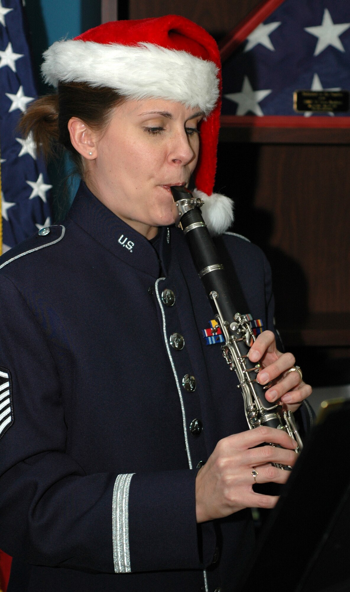 Master Sgt. Noelle Little toots her clarinet for members of the 302nd Airlift Wing Dec. 17, 2008, with a holiday music ensemble in the wing's headquarters building on Peterson Air Force Base in Colorado. Sergeant Little is a member of the U.S. Air Force Academy band. (U.S. Air Force photo/Stephen J. Collier)