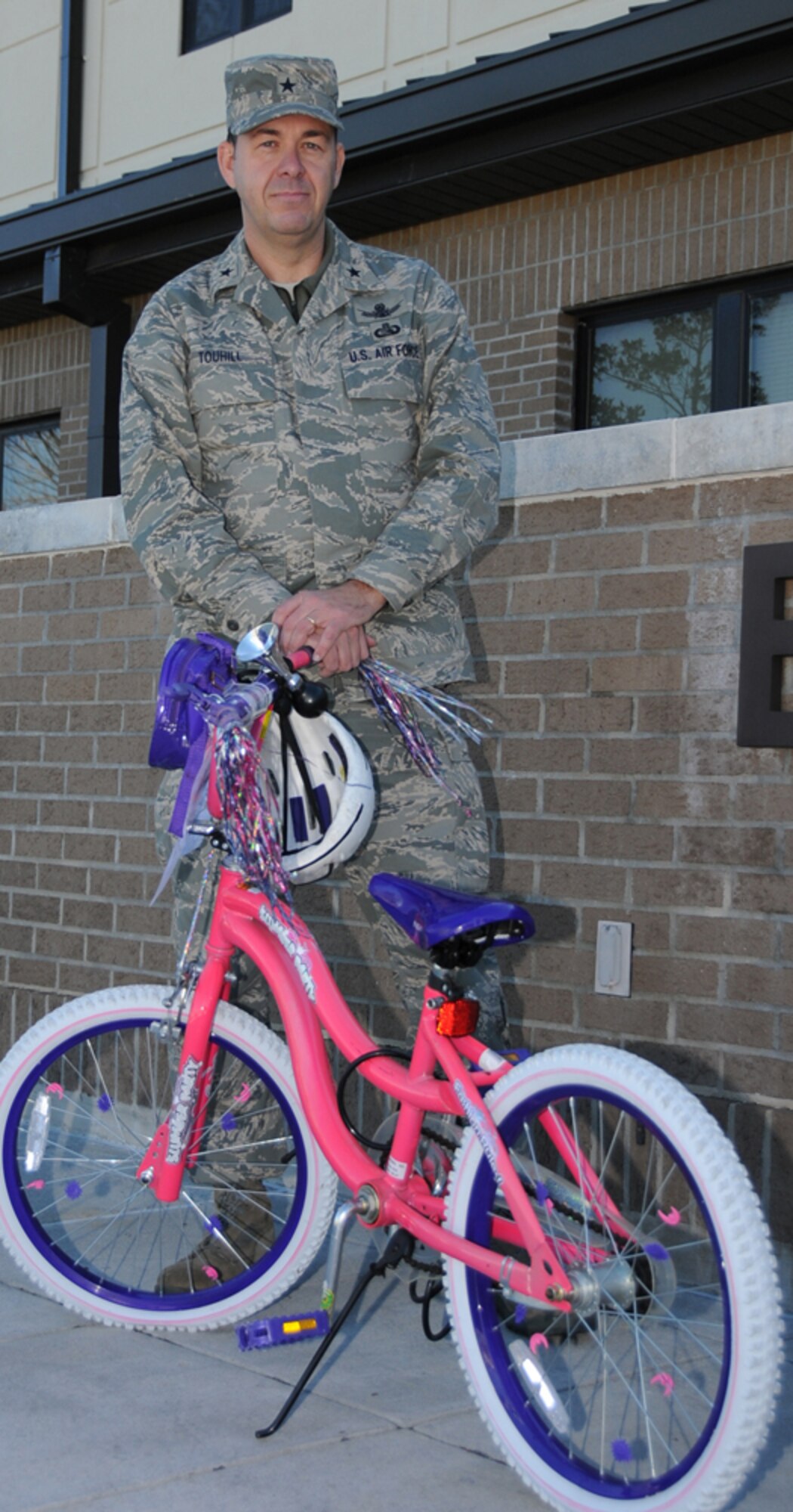 General Touhill stands in front of a child’s bicycle to remind Keesler members of the lives they endanger if they choose to drink and drive.  General Touhill has pledged to ride the bicycle to wing headquarters if the wing goes 81 consecutive days without a DUI incident.  He reminds everyone to have a safe holiday.  (U.S. Air Force photo by Kemberly Groue)
